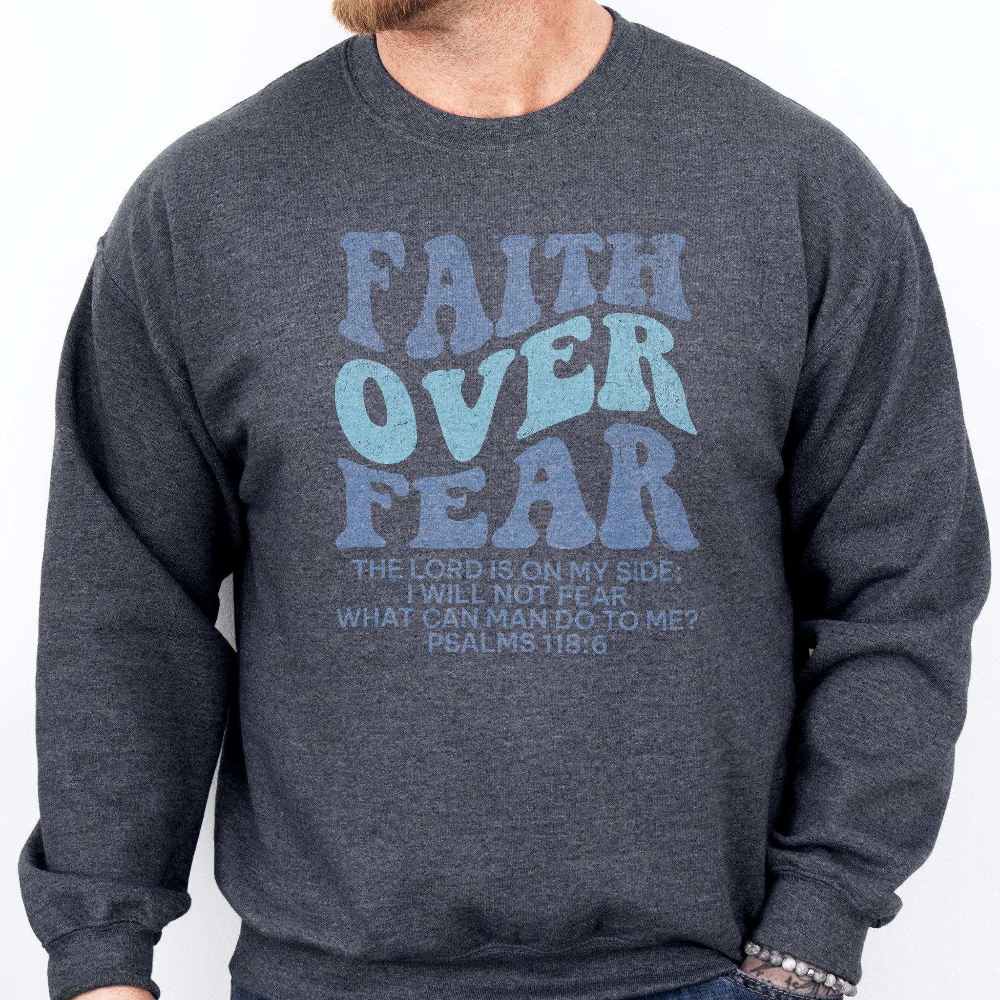 Dark Heather Oakley June sweatshirt, mens fit, large front lettering reads Faith Over Fear with supporting lines The Lord Is On My Side I Will Not Fear What Can Man Do To Me, studio front view