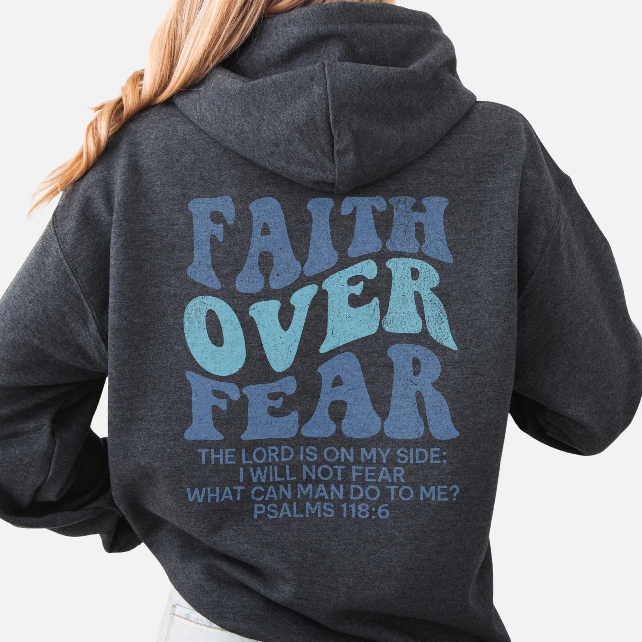 Dark Heather Oakley June hoodie, large back lettering reads Faith Over Fear with supporting scripture lines, hood up, studio back view

