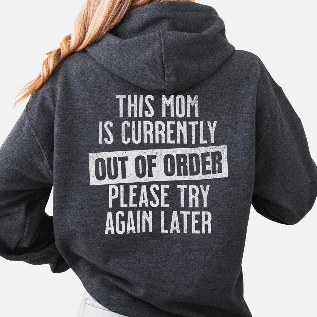 Dark Heather hoodie – large back text reads “This Mom Is Currently Out of Order, Please Try Again Later”, relaxed modern fit with hood up, studio back view