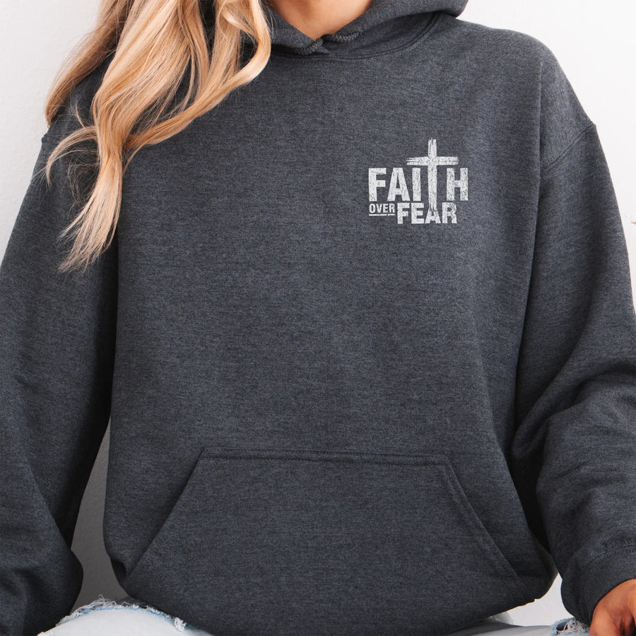 Dark Heather Oakley June hoodie, left chest badge reads Faith Over Fear with small cross, kangaroo pocket and relaxed modern fit, studio front view