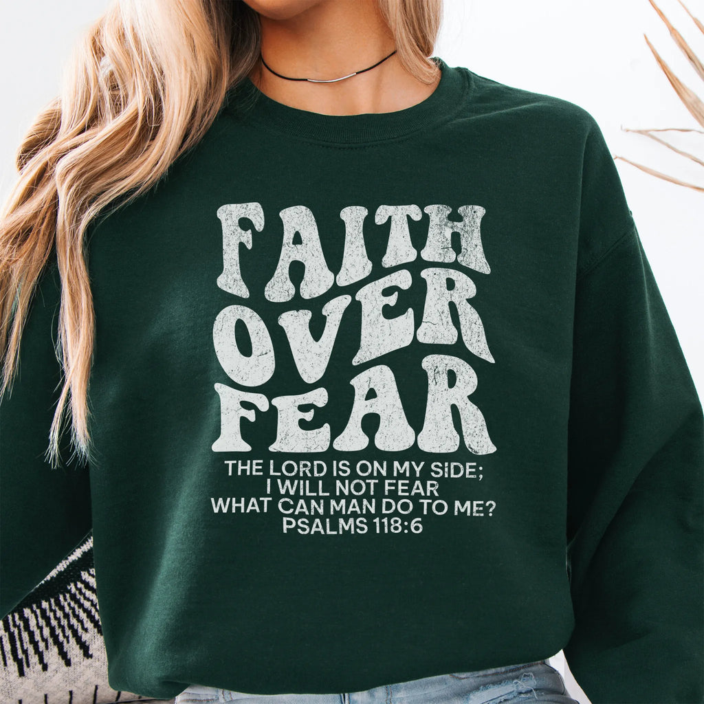 Forest Green Oakley June sweatshirt, large front lettering reads Faith Over Fear with supporting lines The Lord Is On My Side I Will Not Fear What Can Man Do To Me, studio front view