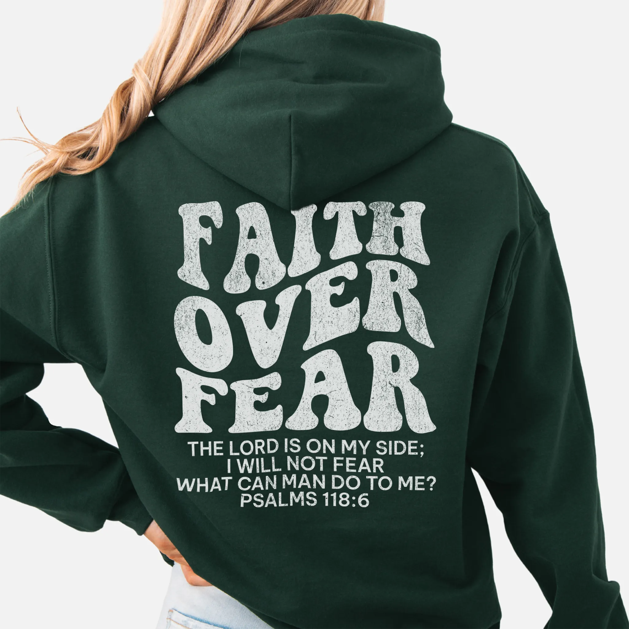 Forest Green Oakley June hoodie, large back lettering reads Faith Over Fear with supporting scripture lines, hood up, studio back view