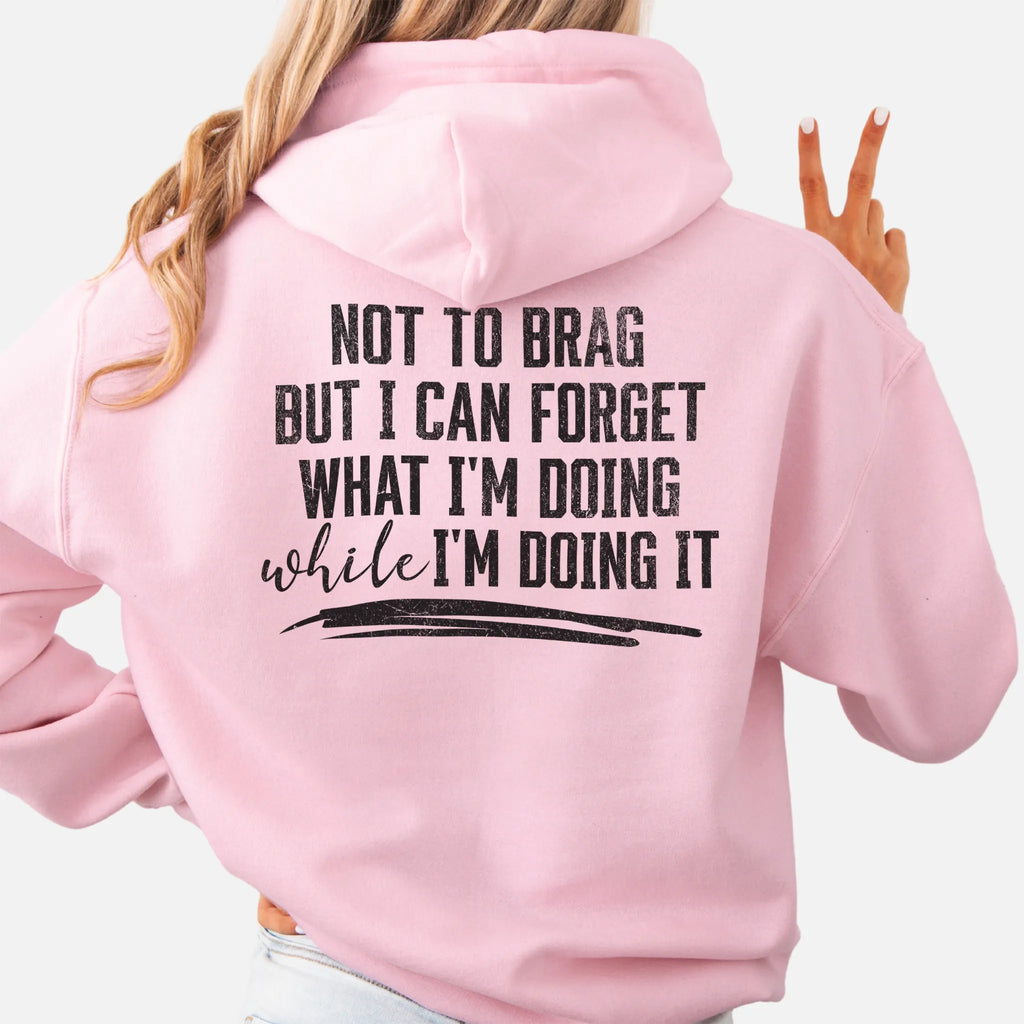 Light Pink Oakley June Hoodie back view large text Not To Brag But I Can Forget What I’m Doing While I’m Doing It underline distressed print