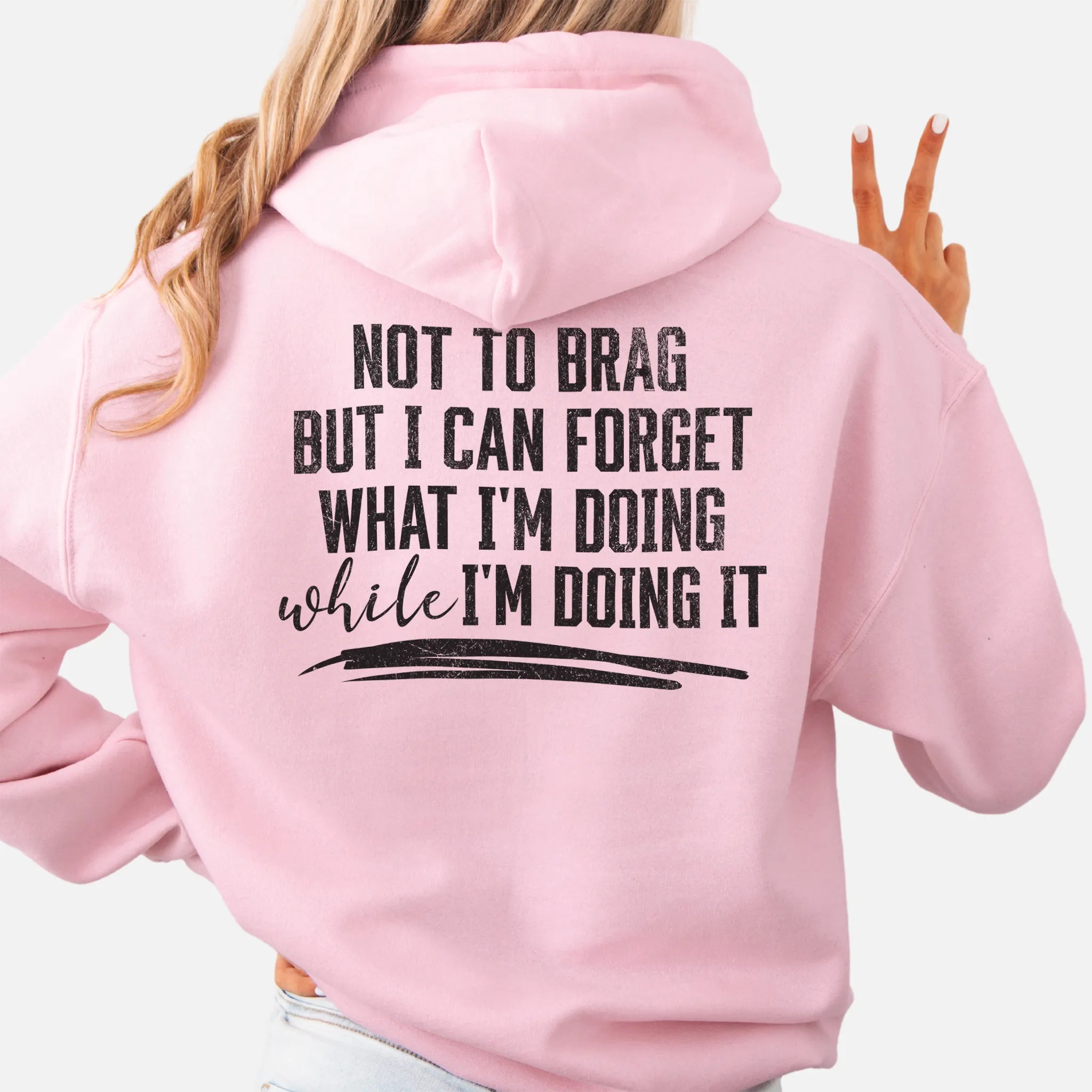 Light Pink Oakley June Hoodie back view large text Not To Brag But I Can Forget What I’m Doing While I’m Doing It underline distressed print