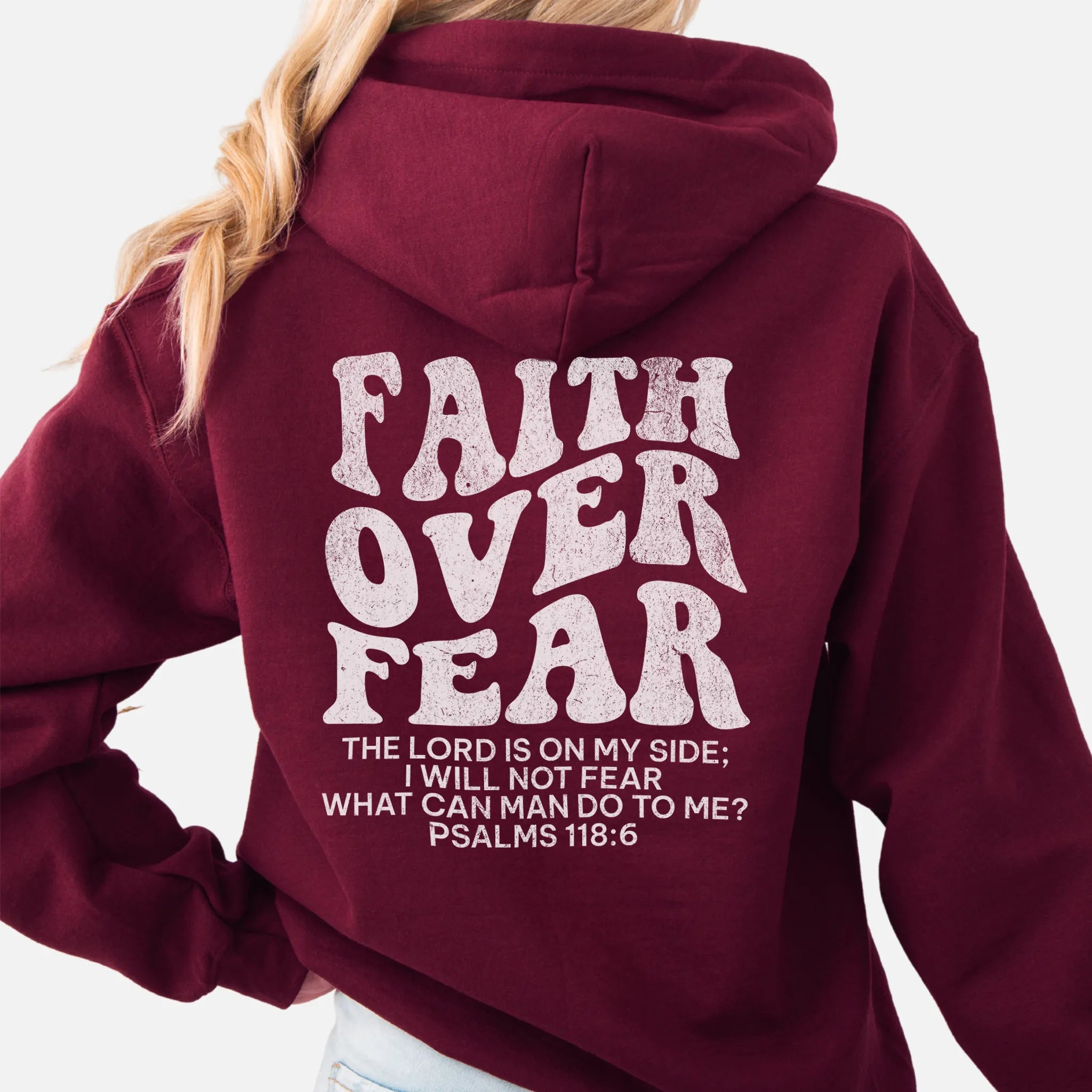 Maroon Oakley June hoodie, large back lettering reads Faith Over Fear with supporting scripture lines, hood up, studio back view