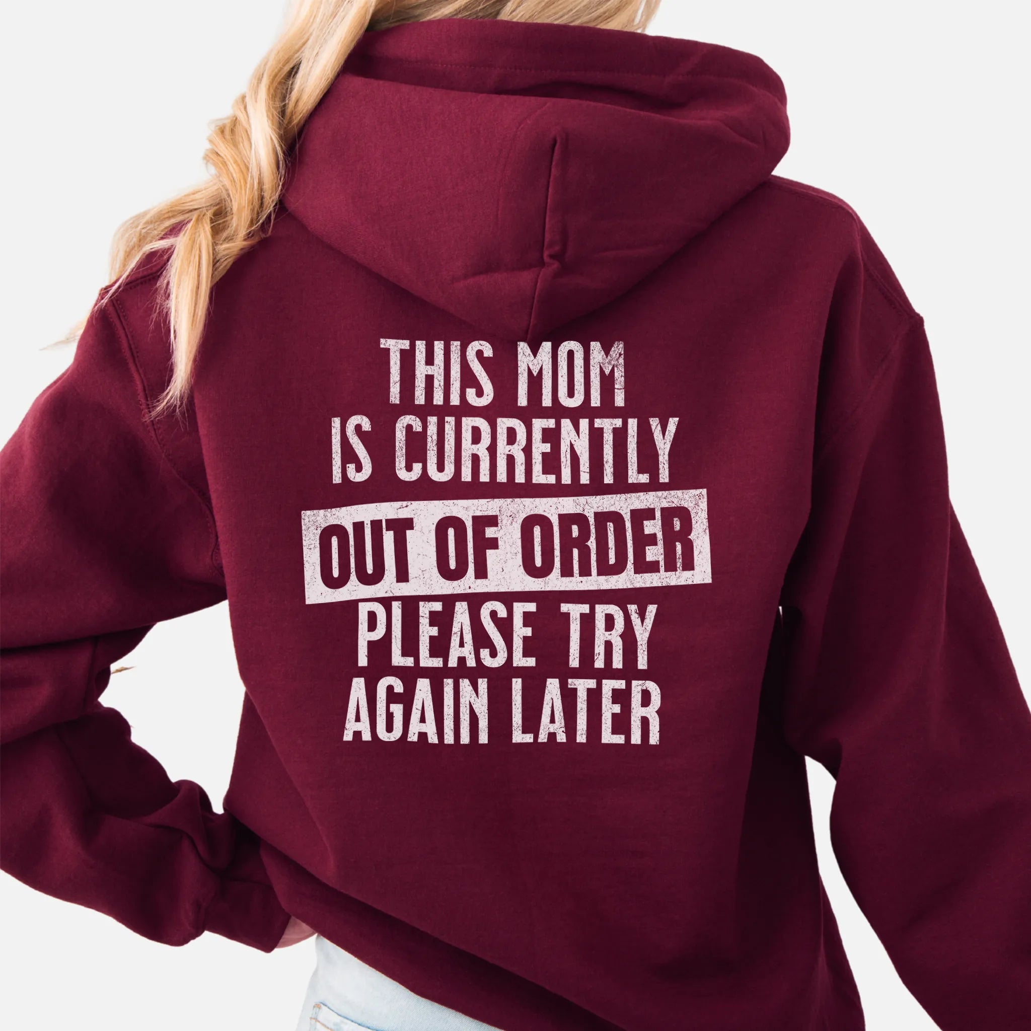 Maroon hoodie – large back text reads “This Mom Is Currently Out of Order, Please Try Again Later”, relaxed modern fit with hood up, studio back view