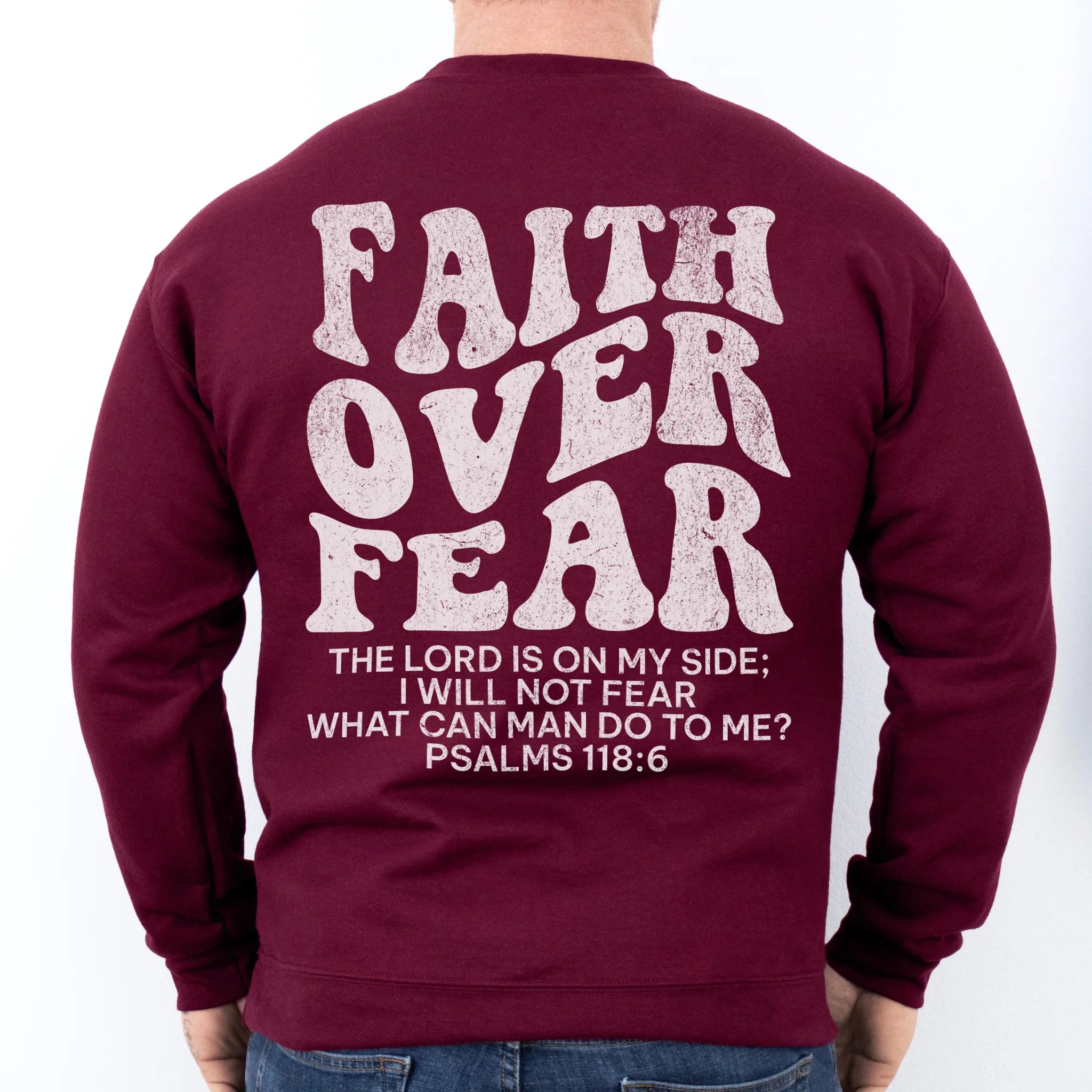 Maroon Oakley June sweatshirt, mens fit, large back lettering reads Faith Over Fear with supporting scripture lines, studio back view