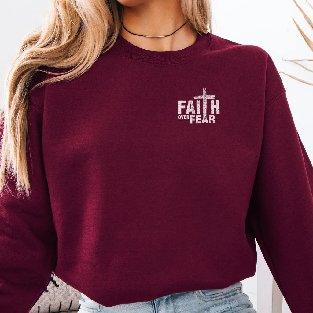 Maroon Oakley June sweatshirt, left chest badge reads Faith Over Fear with small cross, relaxed modern fit, studio front view