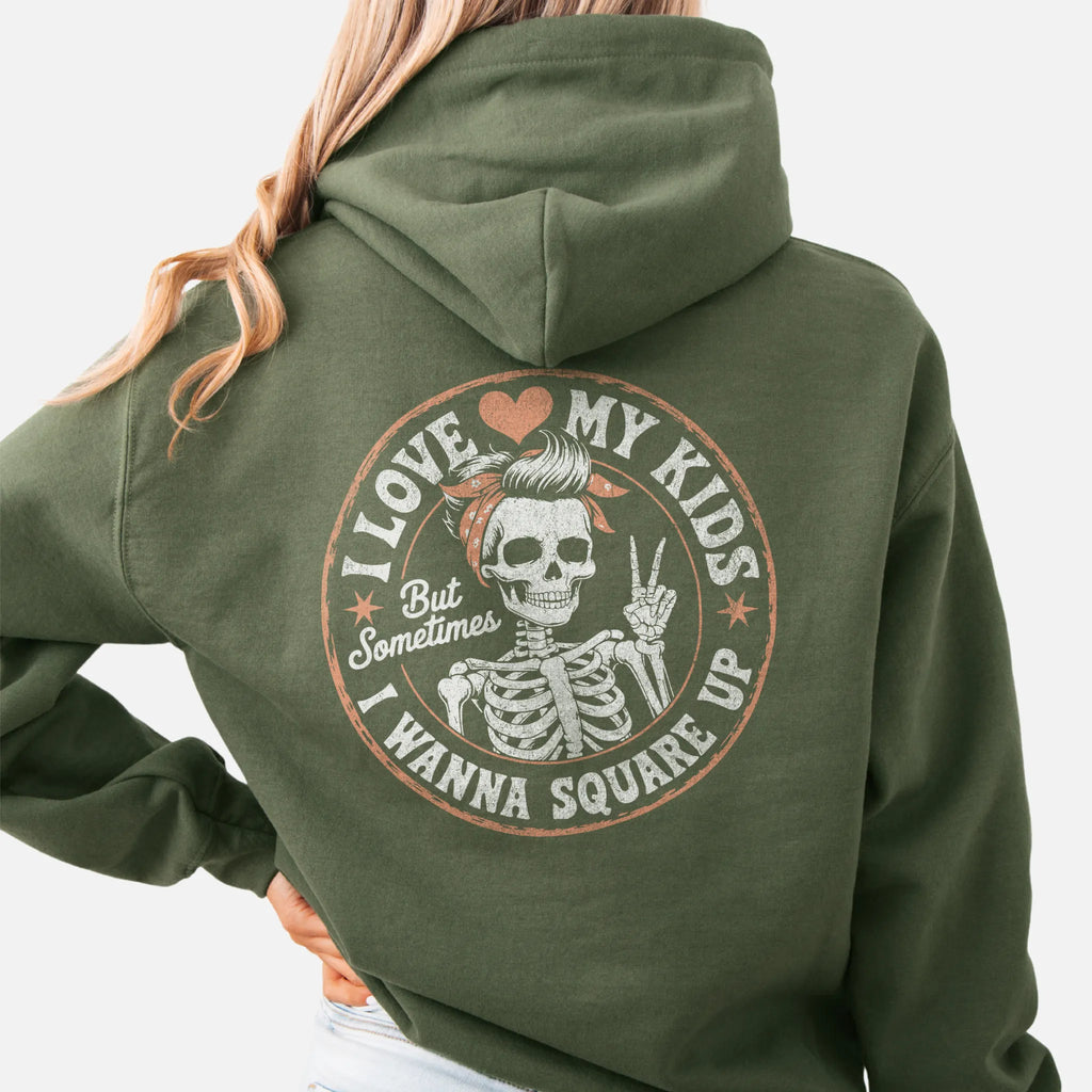 Military Green Oakley June hoodie, large back circle graphic with skeleton mom giving a peace sign, text reads I Love My Kids But Sometimes I Wanna Square Up, studio back view