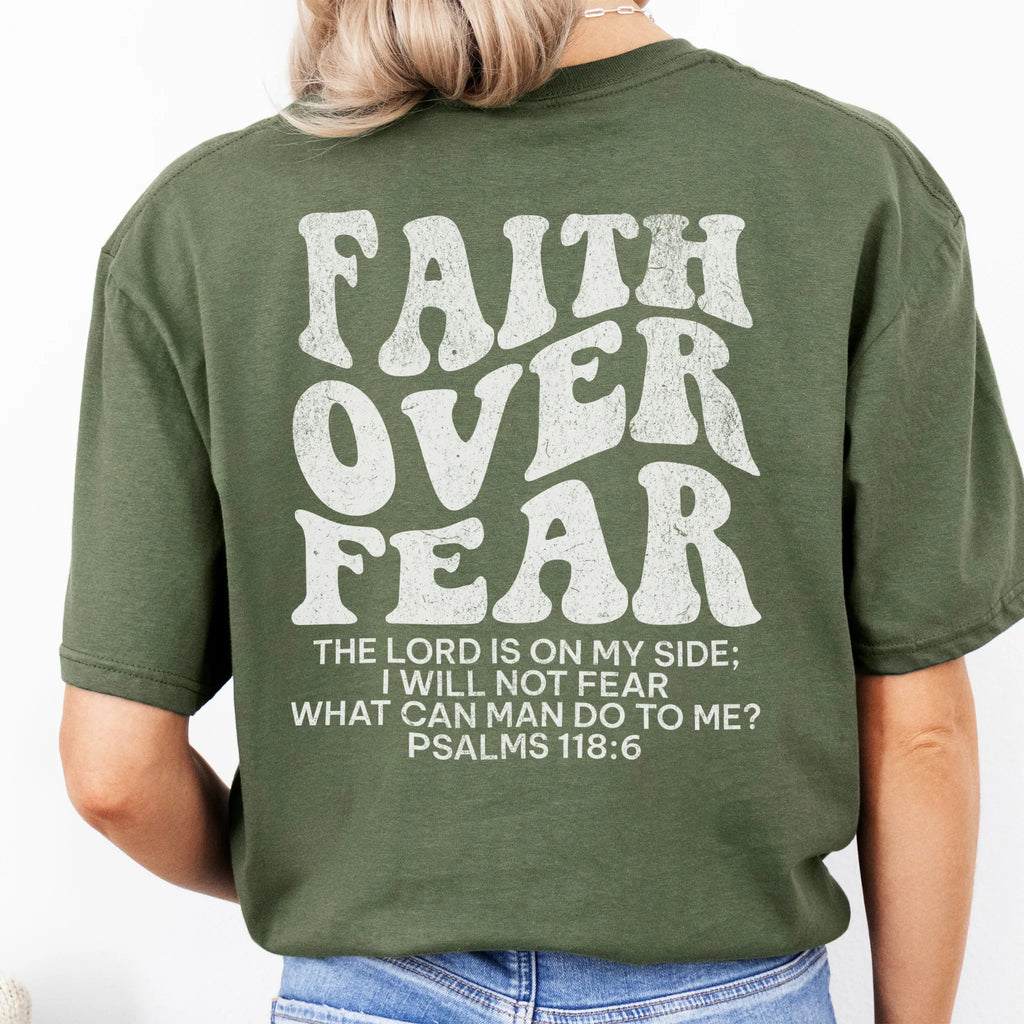 Military Green Oakley June t shirt, large back lettering reads Faith Over Fear with supporting scripture reference Psalms one eighteen six, studio back view