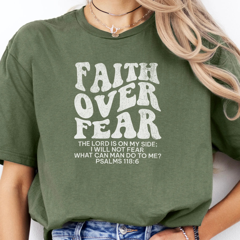 Military Green Oakley June t shirt, large front lettering reads Faith Over Fear with supporting lines The Lord Is On My Side I Will Not Fear What Can Man Do To Me, studio front view