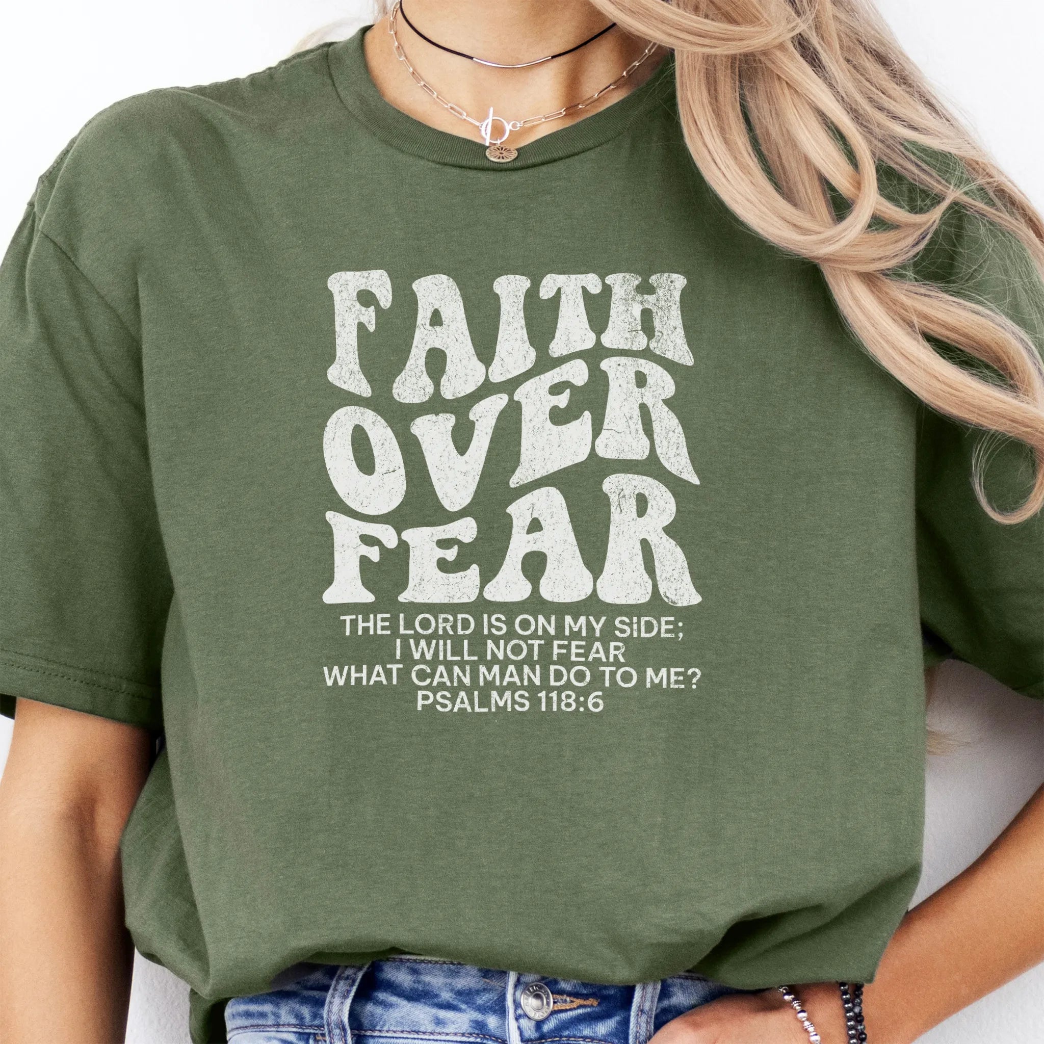 Military Green Oakley June t shirt, large front lettering reads Faith Over Fear with supporting lines The Lord Is On My Side I Will Not Fear What Can Man Do To Me, studio front view