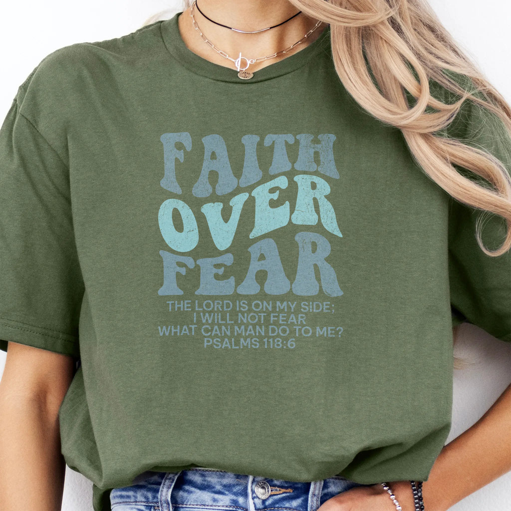 Military Green Oakley June t shirt, large front lettering reads Faith Over Fear with supporting lines The Lord Is On My Side I Will Not Fear What Can Man Do To Me, studio front view