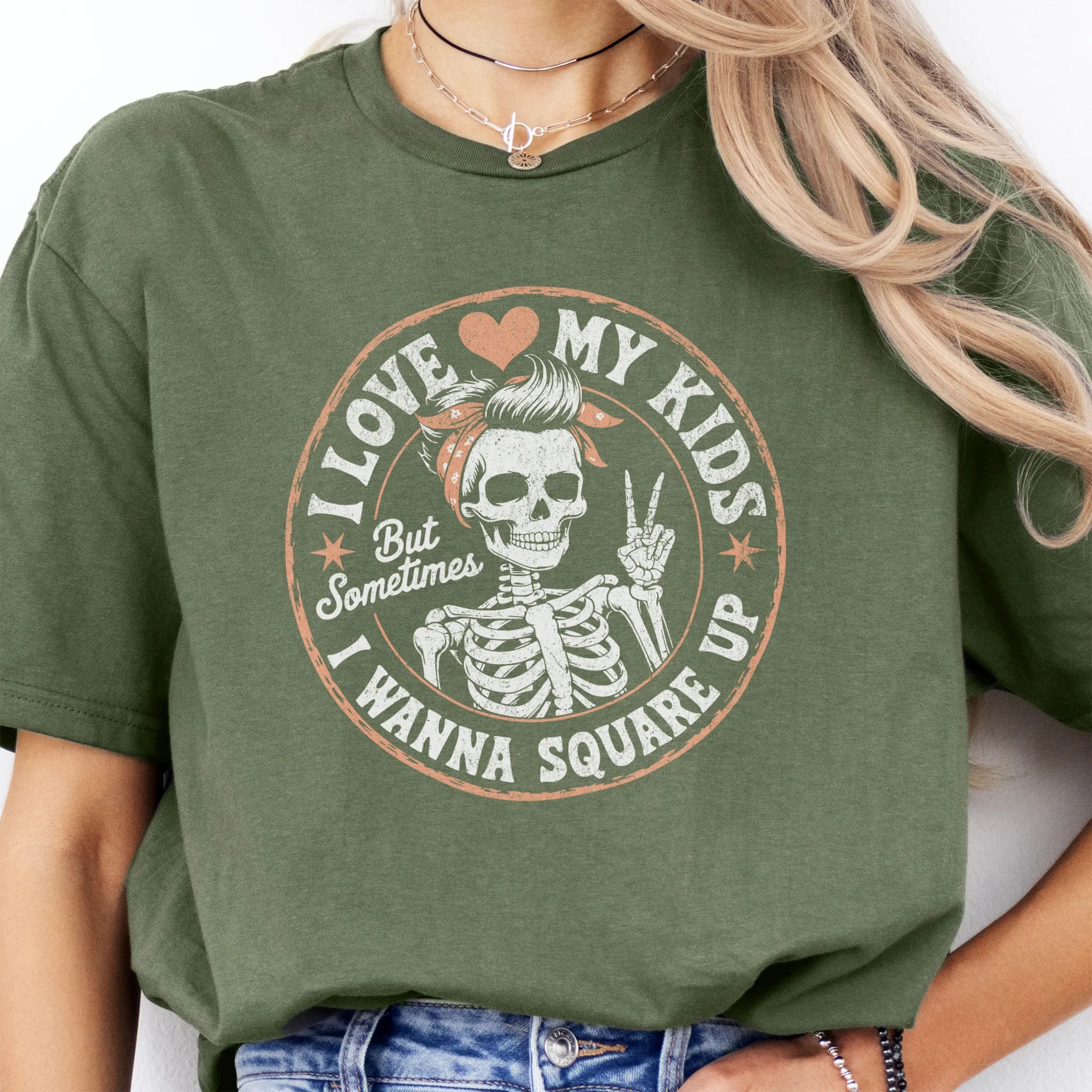 Military Green t-shirt – large front circle graphic with skeleton mom in bandana and peace sign, headline reads “I Love My Kids But Sometimes I Wanna Square Up”, studio front view