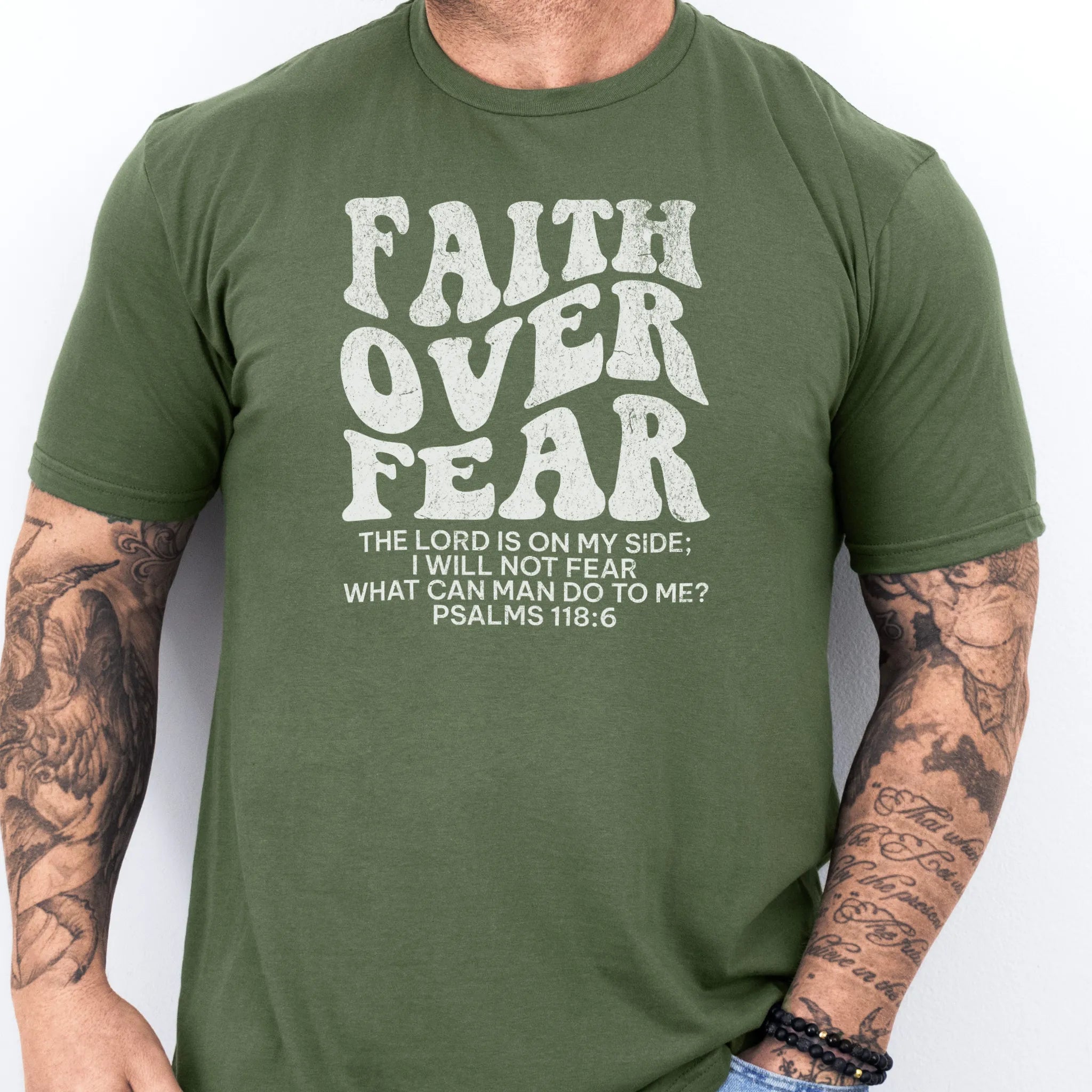 Military Green Oakley June t shirt, mens fit, large front lettering reads Faith Over Fear with supporting scripture lines, studio front view