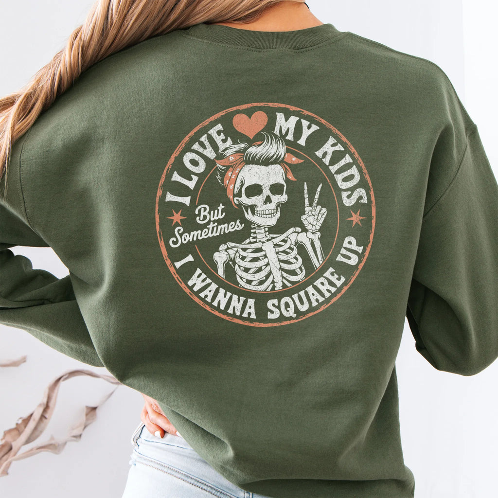 Military Green sweatshirt – large back circle graphic with skeleton mom giving a peace sign, headline reads “I Love My Kids But Sometimes I Wanna Square Up”, studio back view