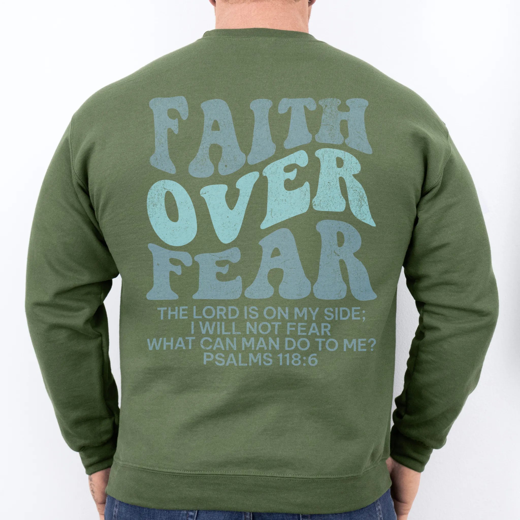 Military Green Oakley June sweatshirt, mens fit, large back lettering reads Faith Over Fear with supporting scripture lines, studio back view