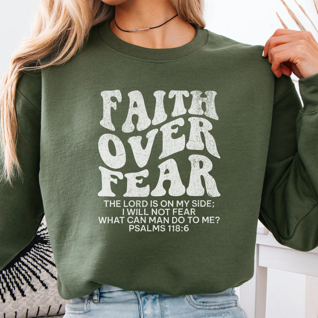 Military Green Oakley June sweatshirt, large front lettering reads Faith Over Fear with supporting lines The Lord Is On My Side I Will Not Fear What Can Man Do To Me, studio front view