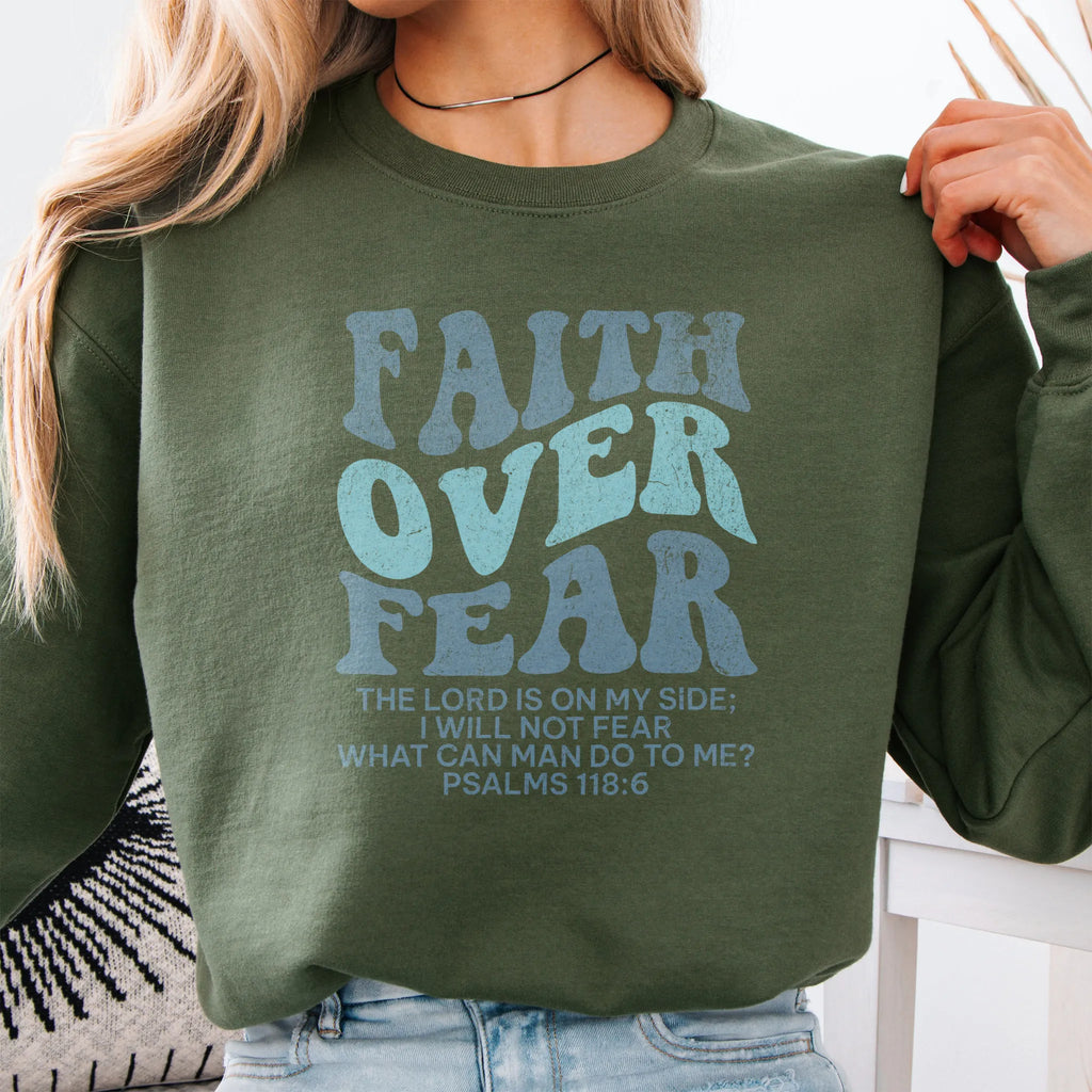Military Green Oakley June sweatshirt, large front lettering reads Faith Over Fear with supporting lines The Lord Is On My Side I Will Not Fear What Can Man Do To Me, studio front view