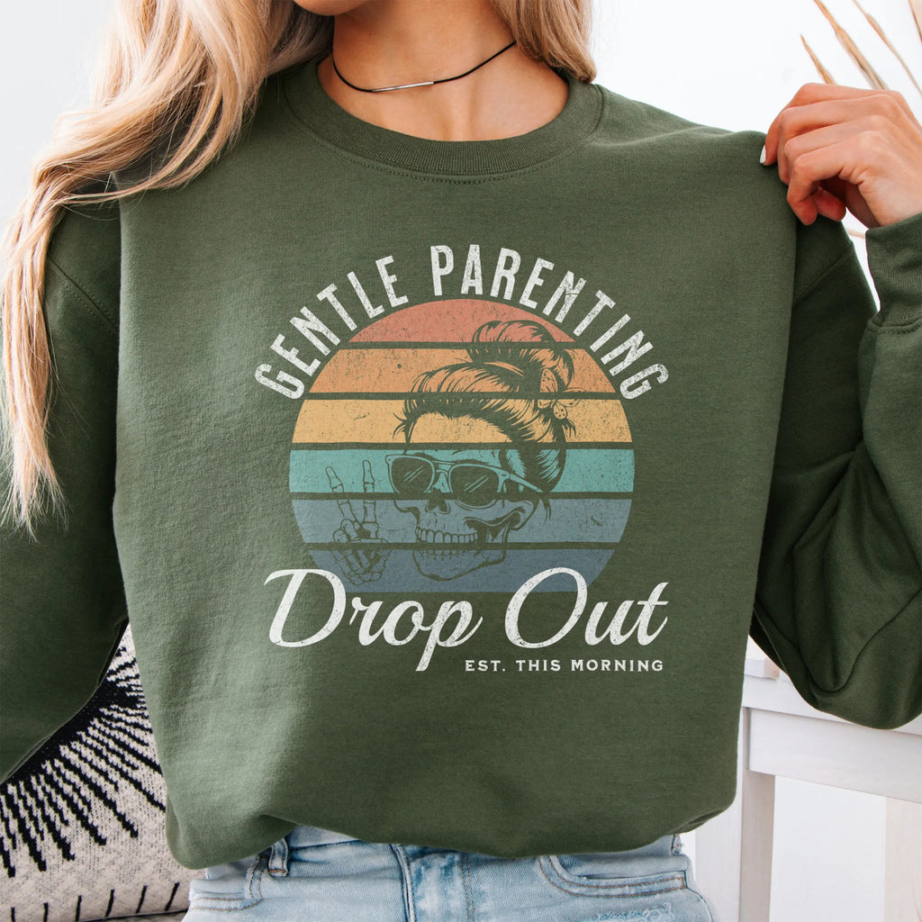 Military Green Oakley June Sweatshirt front view Gentle Parenting Drop Out large chest graphic skull with messy bun peace sign round retro stripe badge text Est This Morning distressed print