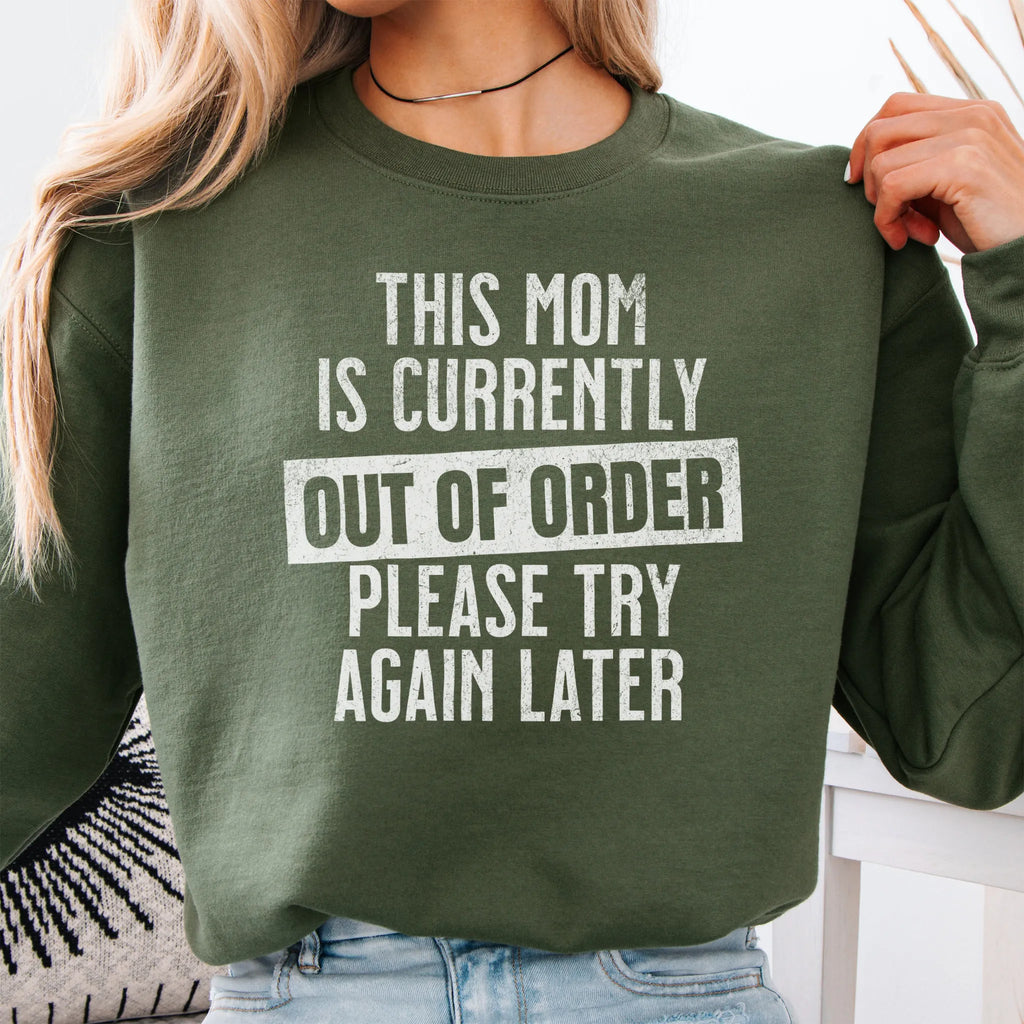 Military Green sweatshirt – large front text reads “This Mom Is Currently Out of Order, Please Try Again Later”, relaxed modern fit, cropped to torso, studio front view