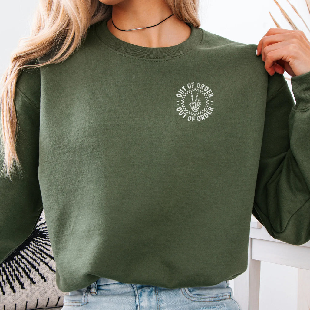 Military Green sweatshirt – left chest “Out of Order” circular badge, relaxed modern fit, cropped to torso, studio front view