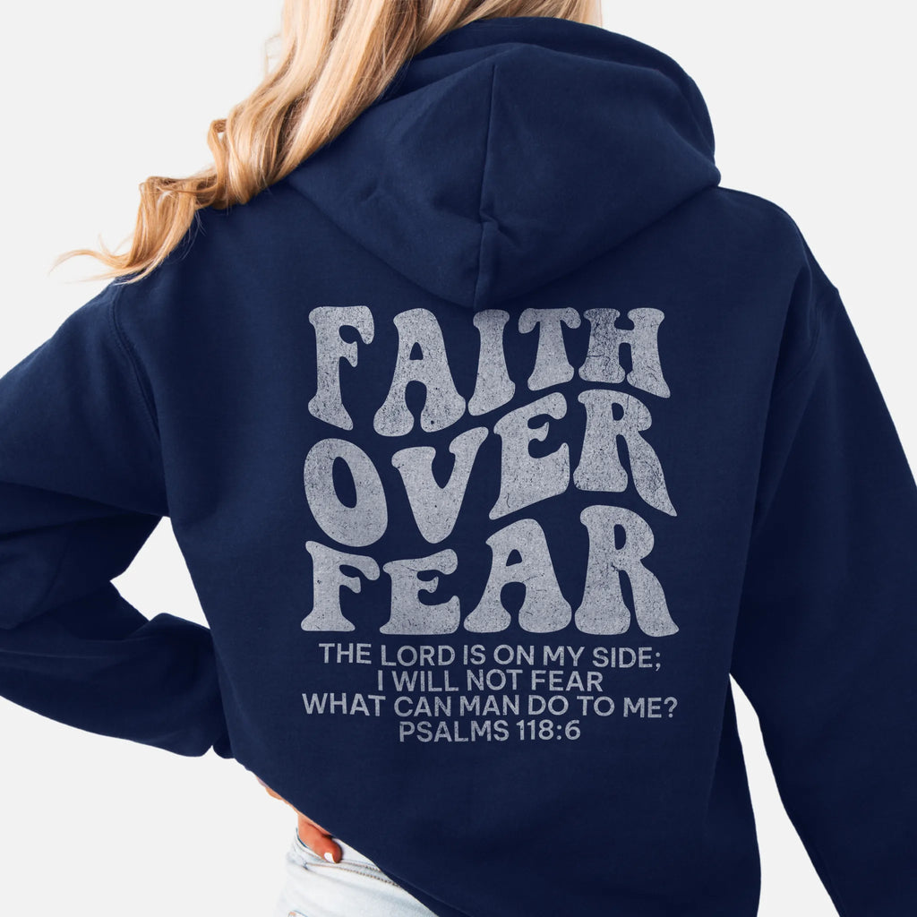Navy Oakley June hoodie, large back lettering reads Faith Over Fear with supporting scripture lines, hood up, studio back view