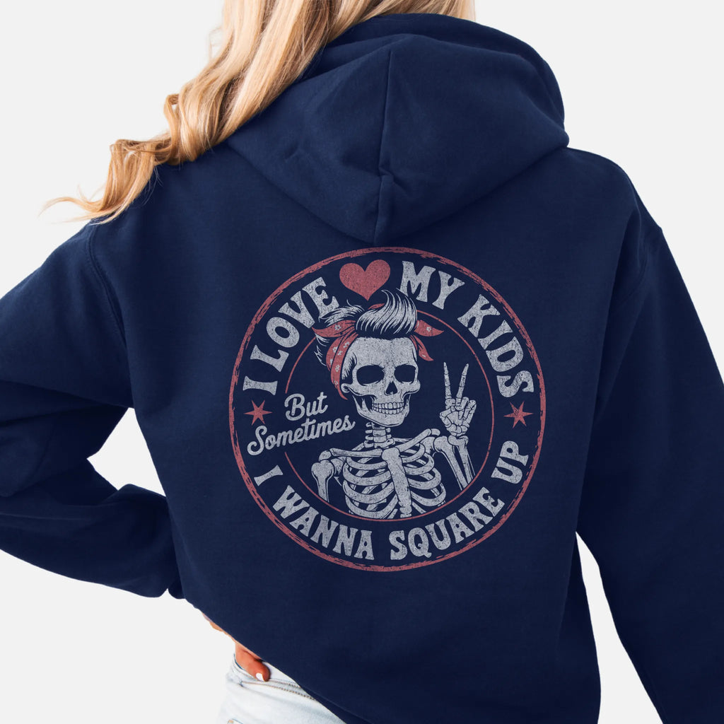 Navy Oakley June hoodie, large back circle graphic with skeleton mom giving a peace sign, text reads I Love My Kids But Sometimes I Wanna Square Up, studio back view