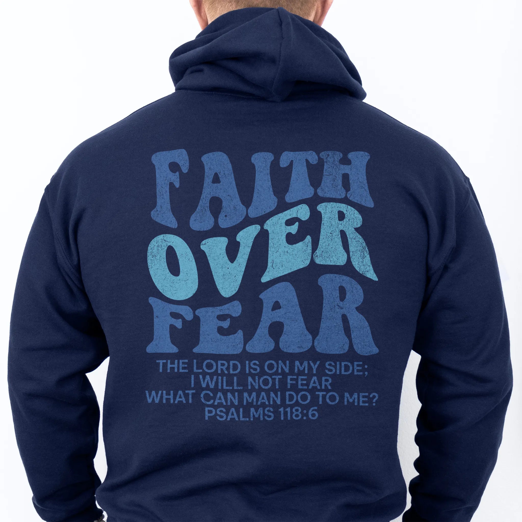 Navy Oakley June hoodie, mens fit, large back lettering reads Faith Over Fear with supporting scripture lines, hood up, studio back view