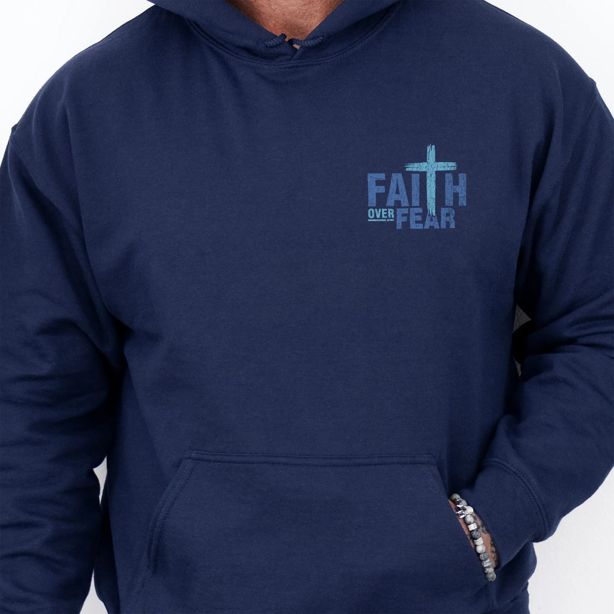 Navy Oakley June hoodie, mens fit, left chest badge reads Faith Over Fear with cross, kangaroo pocket and relaxed modern fit, studio front view