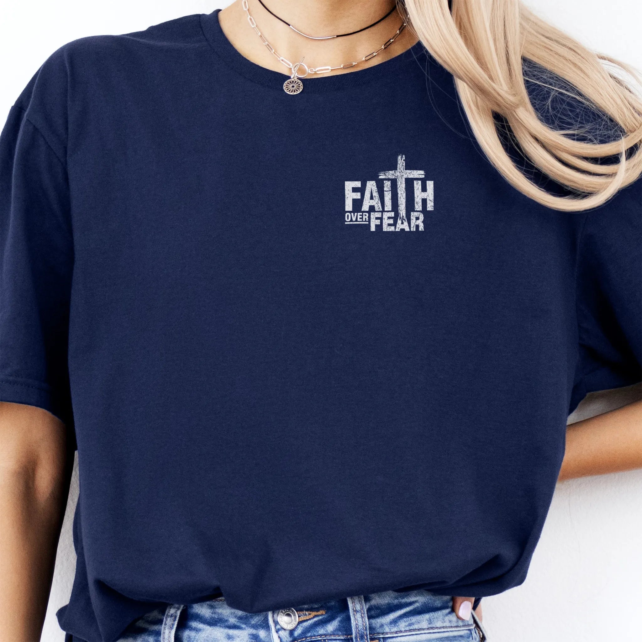Navy Oakley June t shirt, left chest badge reads Faith Over Fear with small cross, relaxed modern fit, studio front view