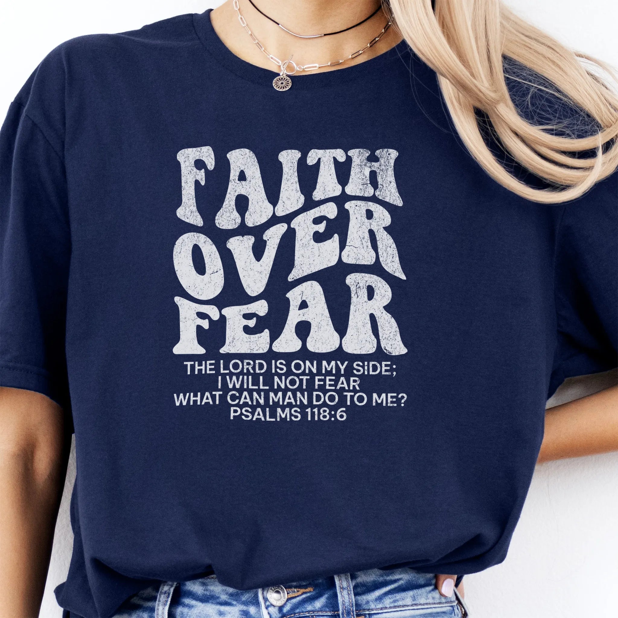 Navy Oakley June t shirt, large front lettering reads Faith Over Fear with supporting lines The Lord Is On My Side I Will Not Fear What Can Man Do To Me, studio front view