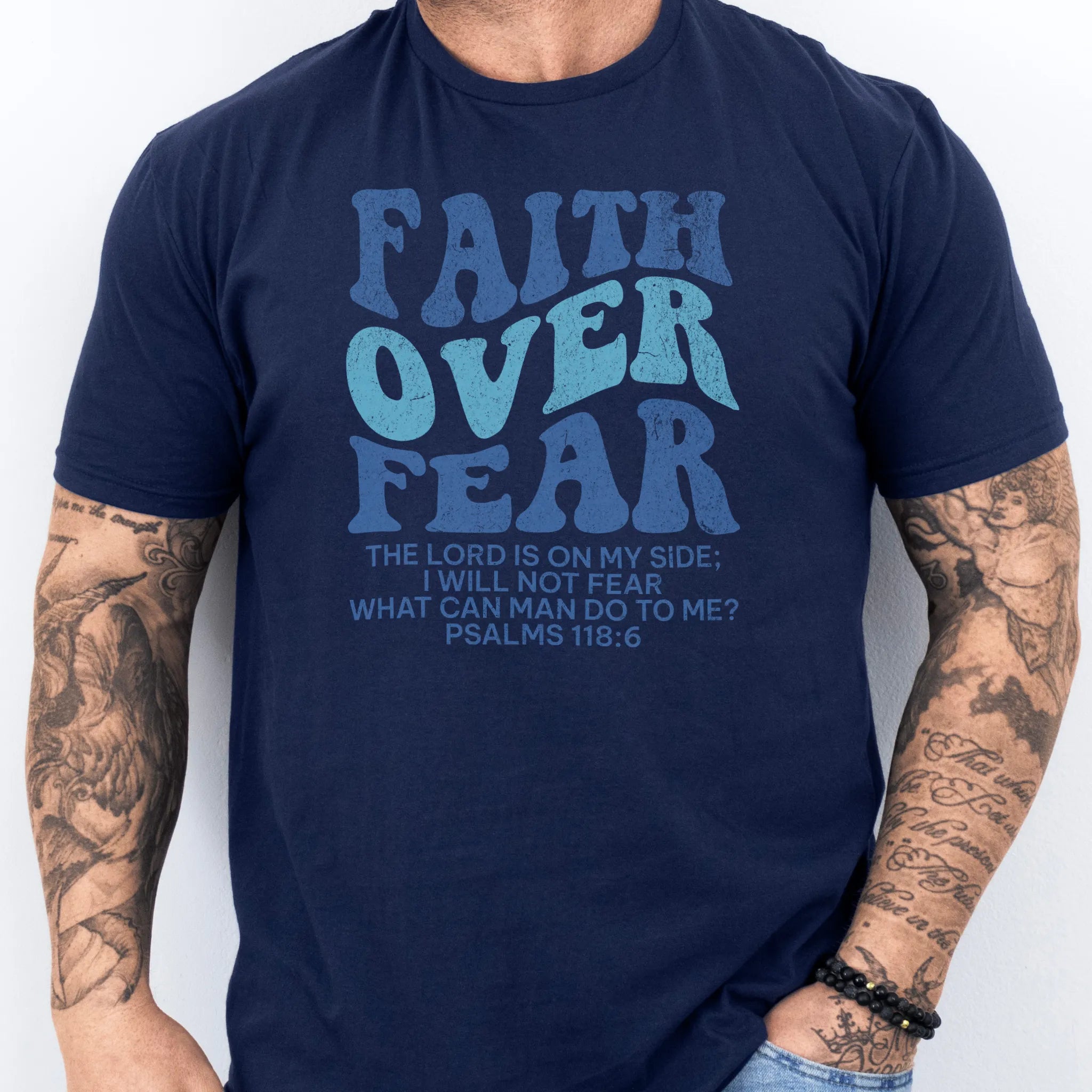 Navy Oakley June t shirt, mens fit, large front lettering reads Faith Over Fear with supporting lines The Lord Is On My Side I Will Not Fear What Can Man Do To Me, studio front view