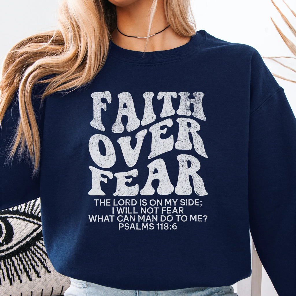 Navy Oakley June sweatshirt, large front lettering reads Faith Over Fear with supporting lines The Lord Is On My Side I Will Not Fear What Can Man Do To Me, studio front view