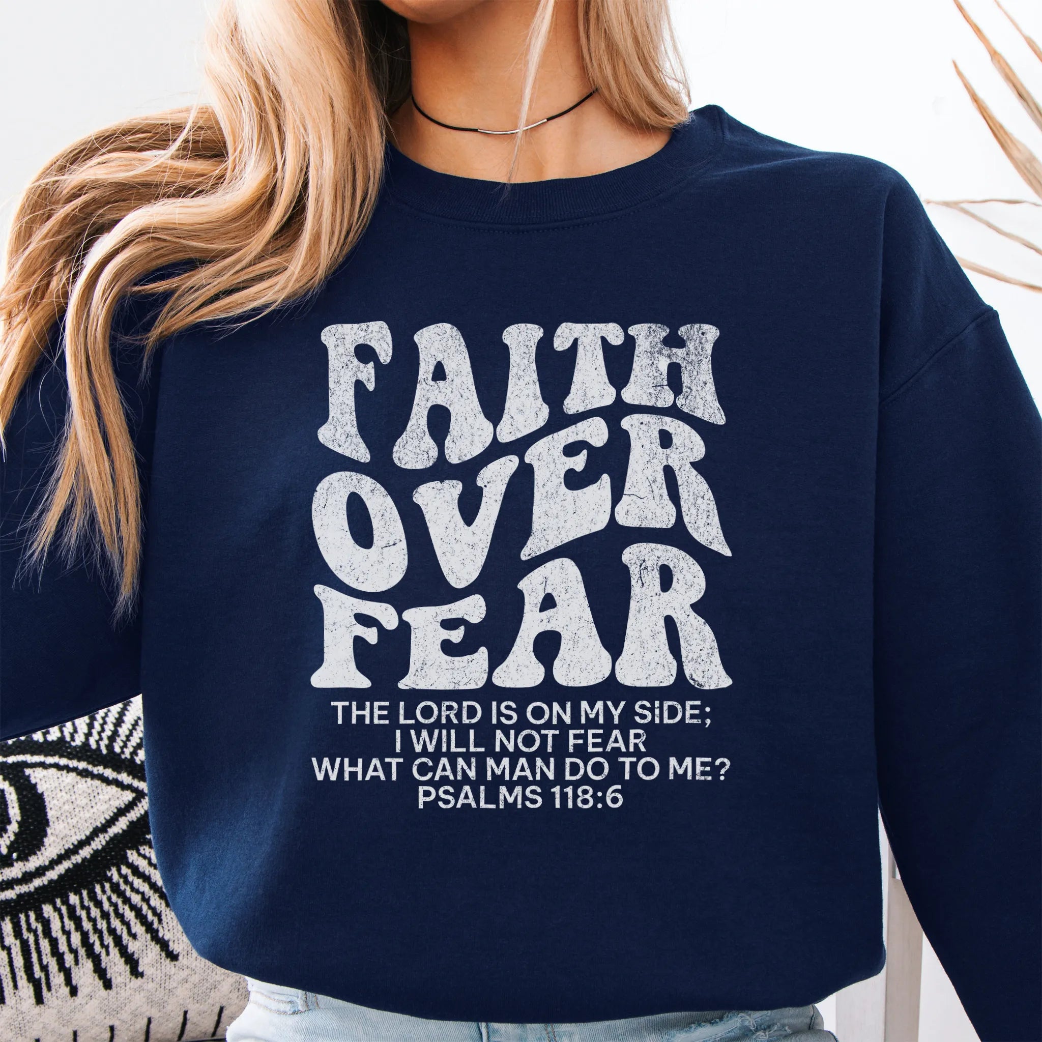 Navy Oakley June sweatshirt, large front lettering reads Faith Over Fear with supporting lines The Lord Is On My Side I Will Not Fear What Can Man Do To Me, studio front view