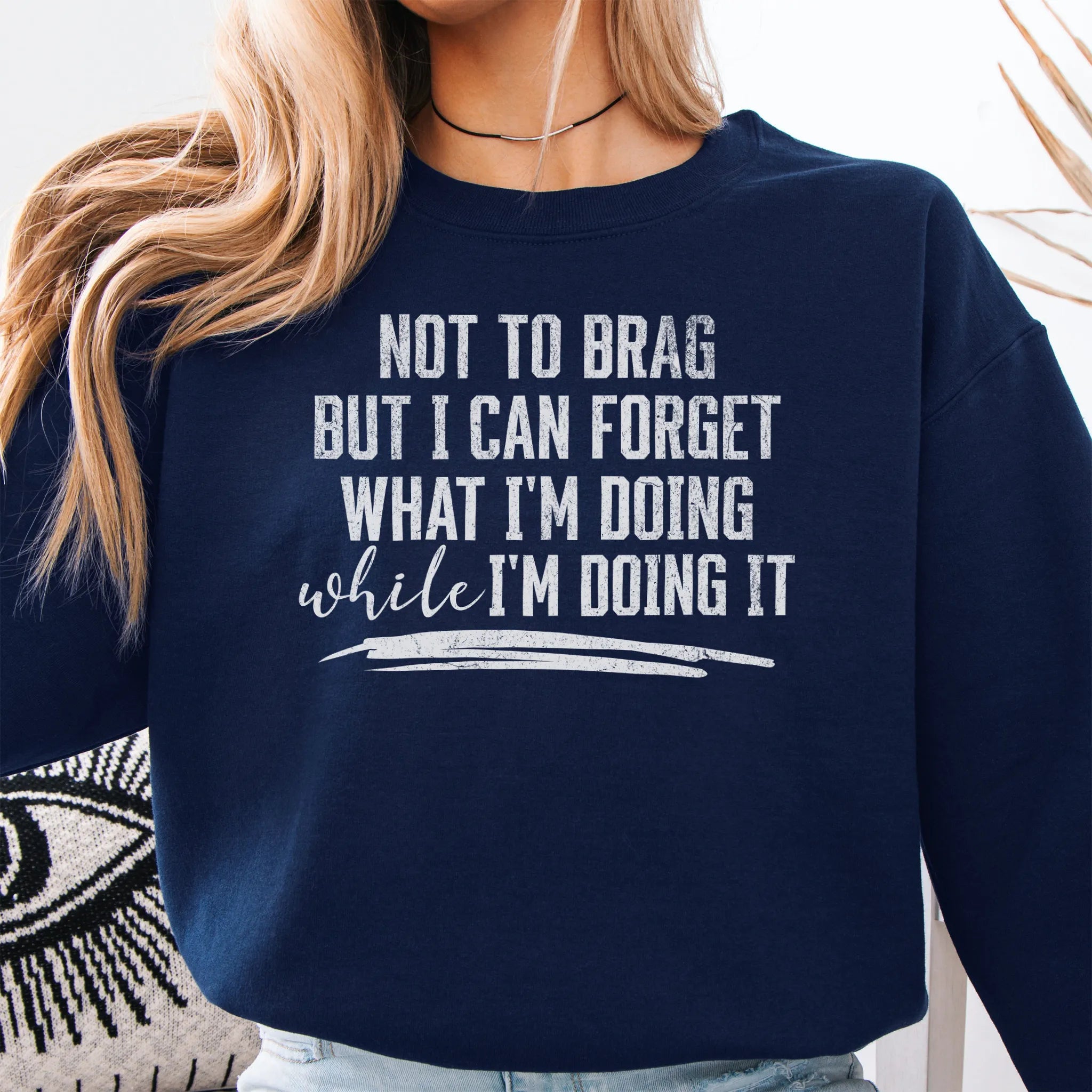 Navy Oakley June Sweatshirt front view large text Not To Brag But I Can Forget What I’m Doing While I’m Doing It underline distressed print