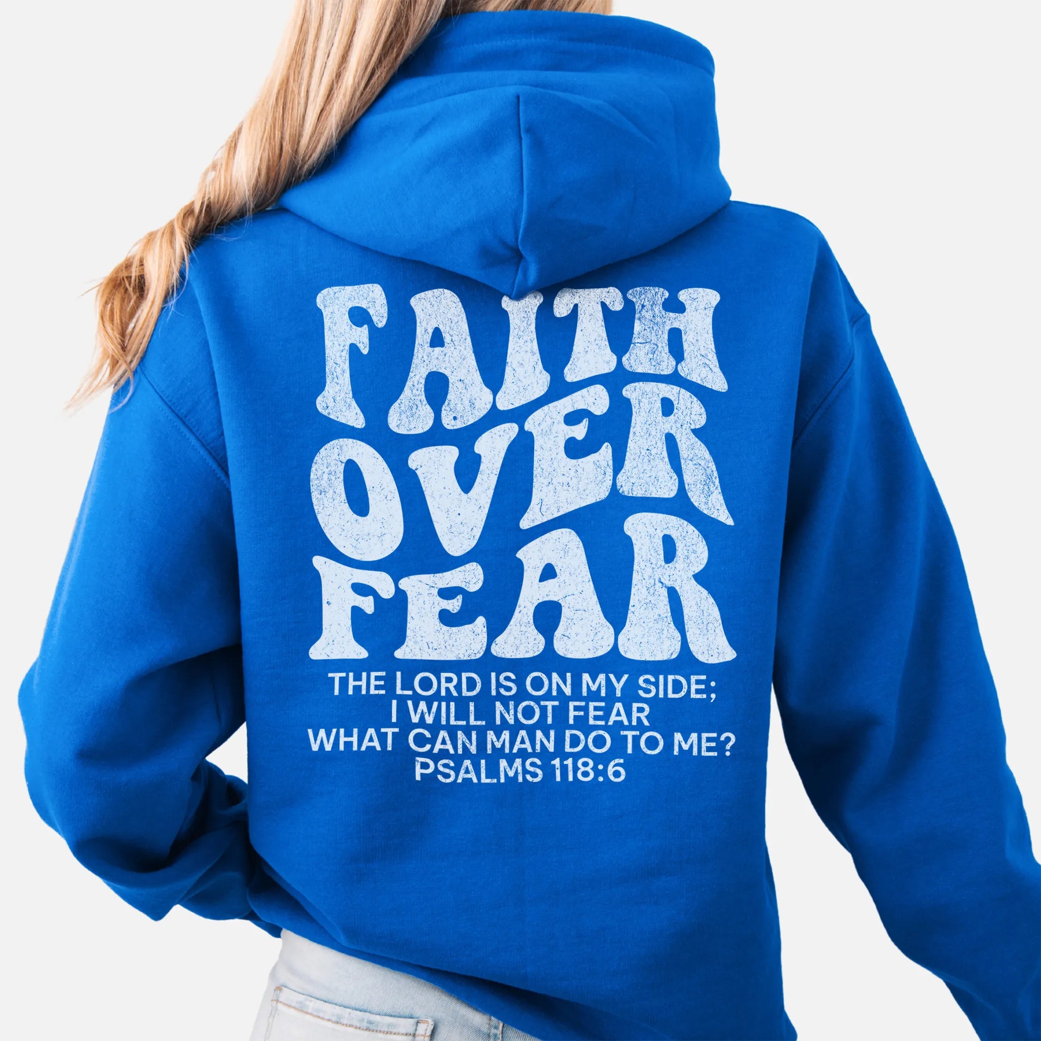 Royal Oakley June hoodie, large back lettering reads Faith Over Fear with supporting scripture lines, hood up, studio back view