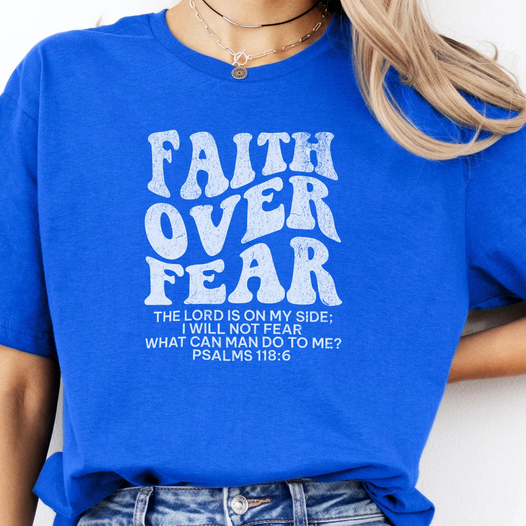 Royal Oakley June t shirt, large front lettering reads Faith Over Fear with supporting lines The Lord Is On My Side I Will Not Fear What Can Man Do To Me, studio front view