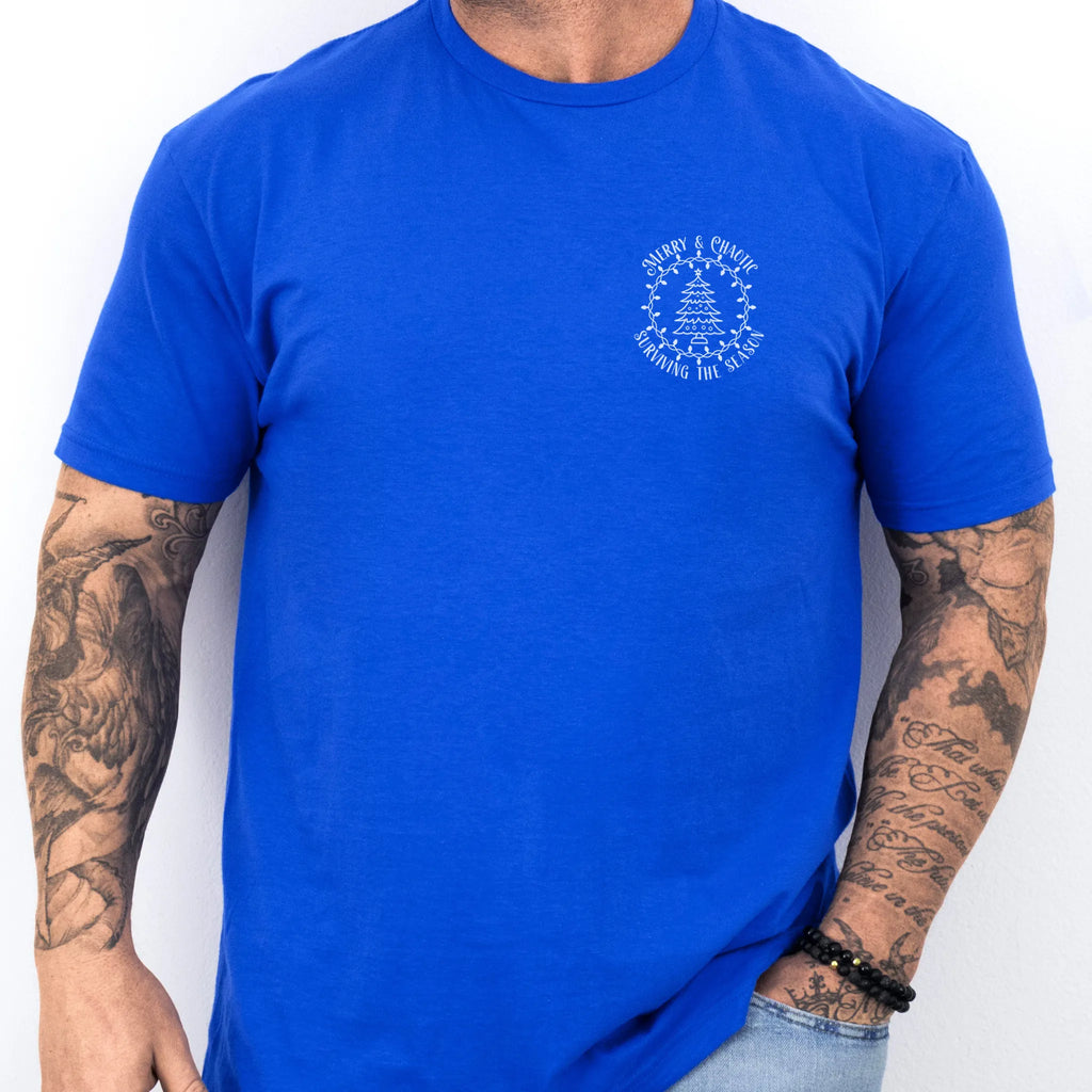 Royal Oakley June tee left chest badge text “Merry & Chaotic — Surviving the Season” with Christmas tree