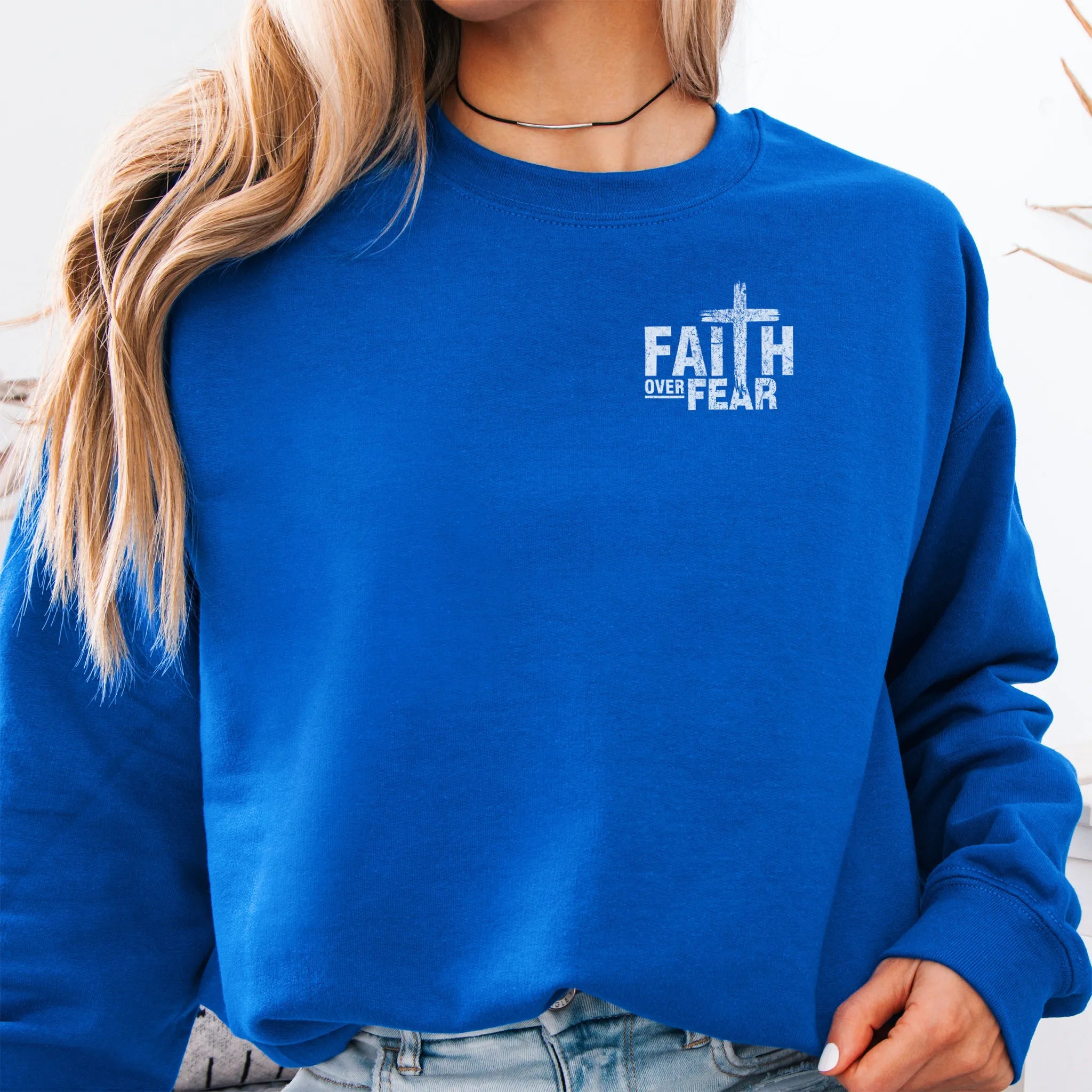 Royal Oakley June sweatshirt, left chest badge reads Faith Over Fear with small cross, relaxed modern fit, studio front view