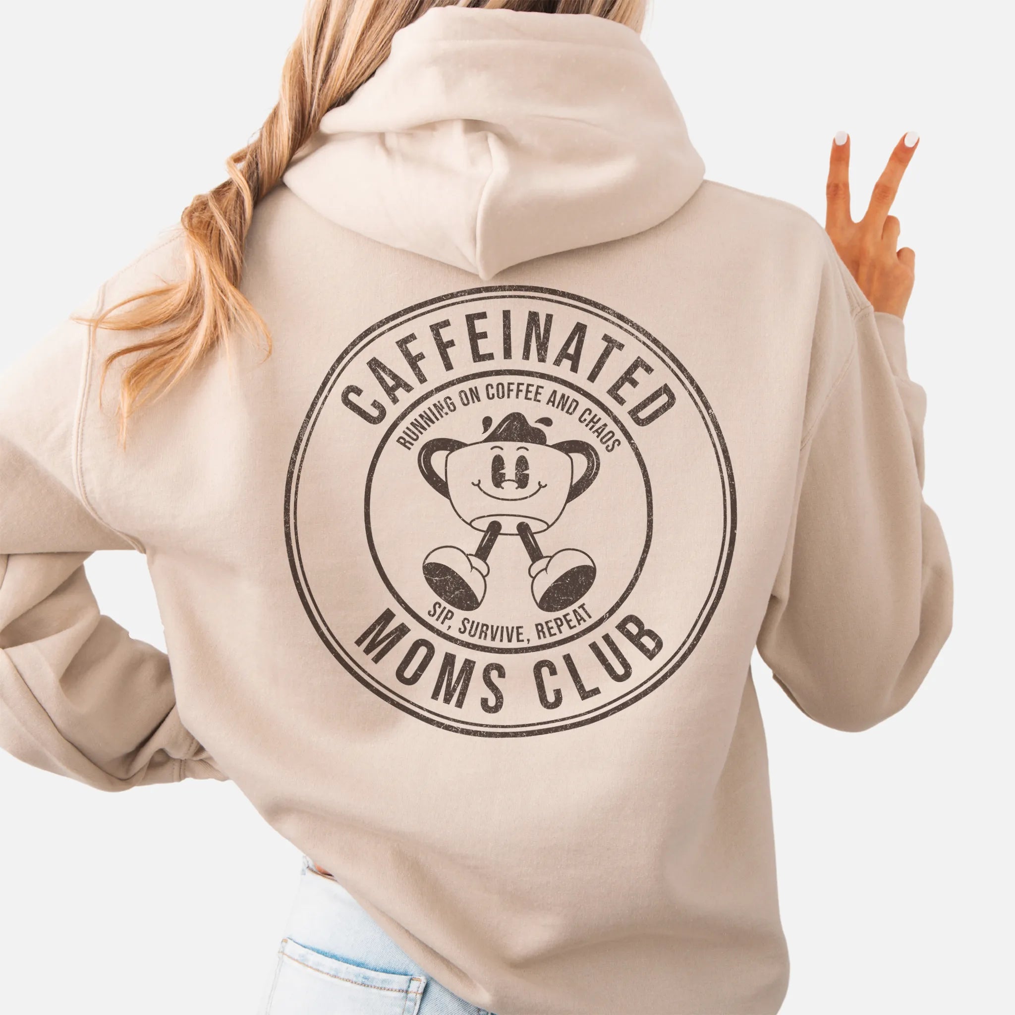 Sand Oakley June Hoodie back view Caffeinated Moms Club large circle badge coffee cup mascot text Running on Coffee and Chaos Sip Survive Repeat distressed print