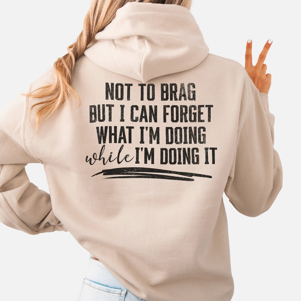 Sand Oakley June Hoodie back view large text Not To Brag But I Can Forget What I’m Doing While I’m Doing It underline distressed print