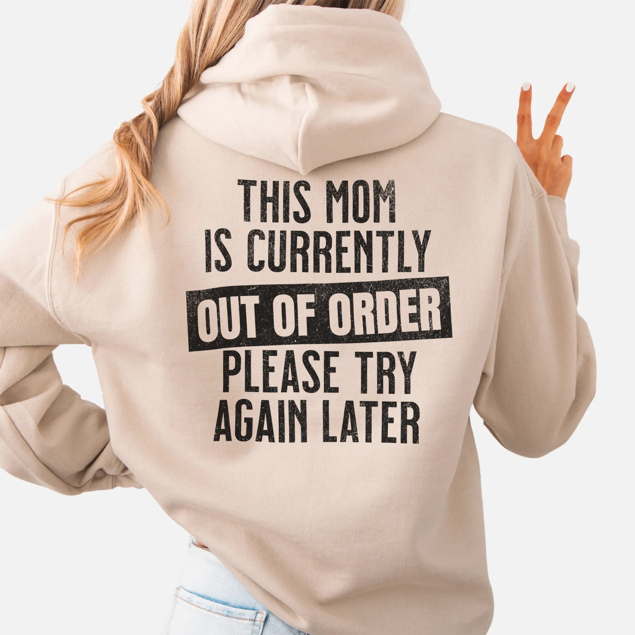 Sand hoodie – large back text reads “This Mom Is Currently Out of Order, Please Try Again Later”, relaxed modern fit with hood up, studio back view
