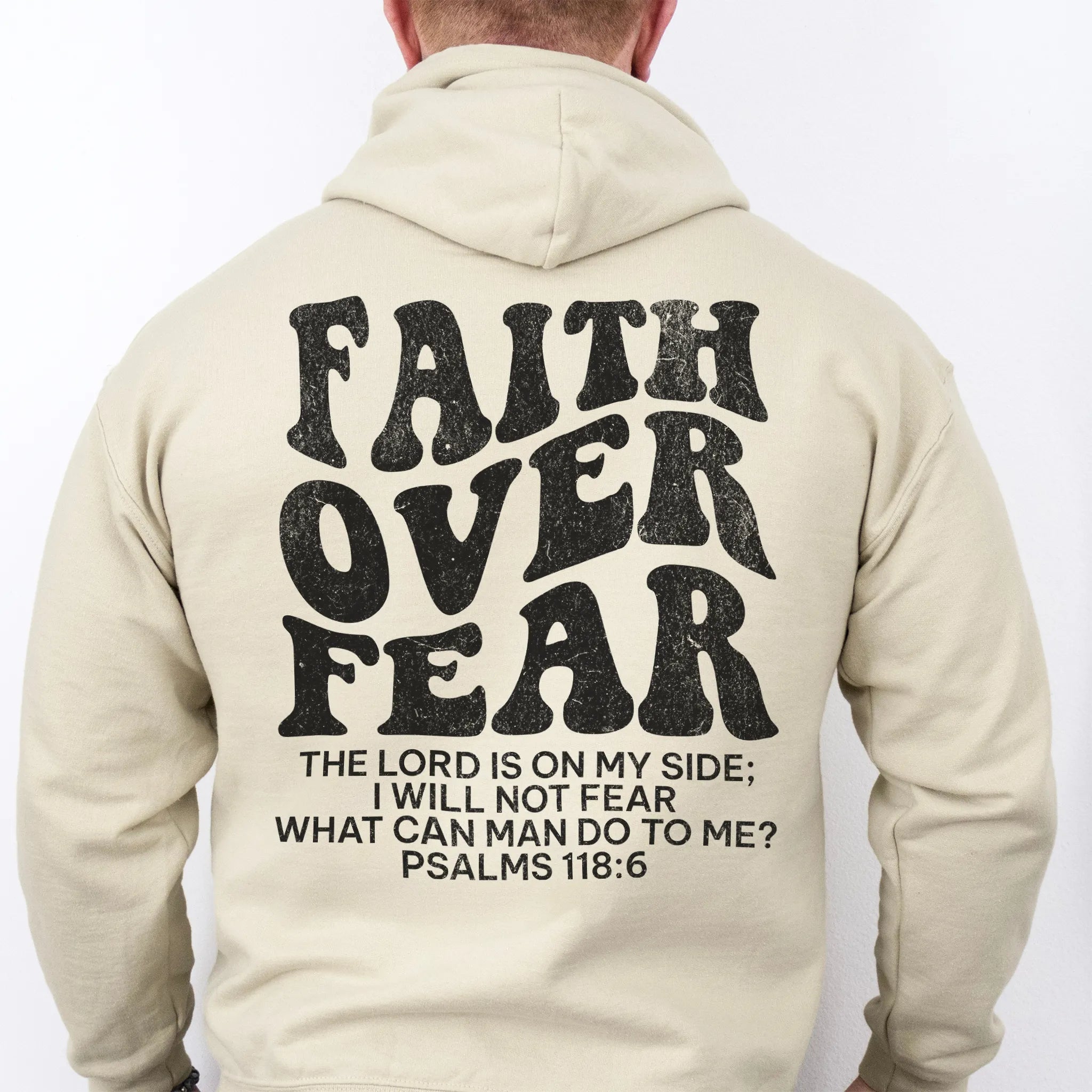 Sand Oakley June hoodie, mens fit, large back lettering reads Faith Over Fear with supporting scripture lines, studio back view