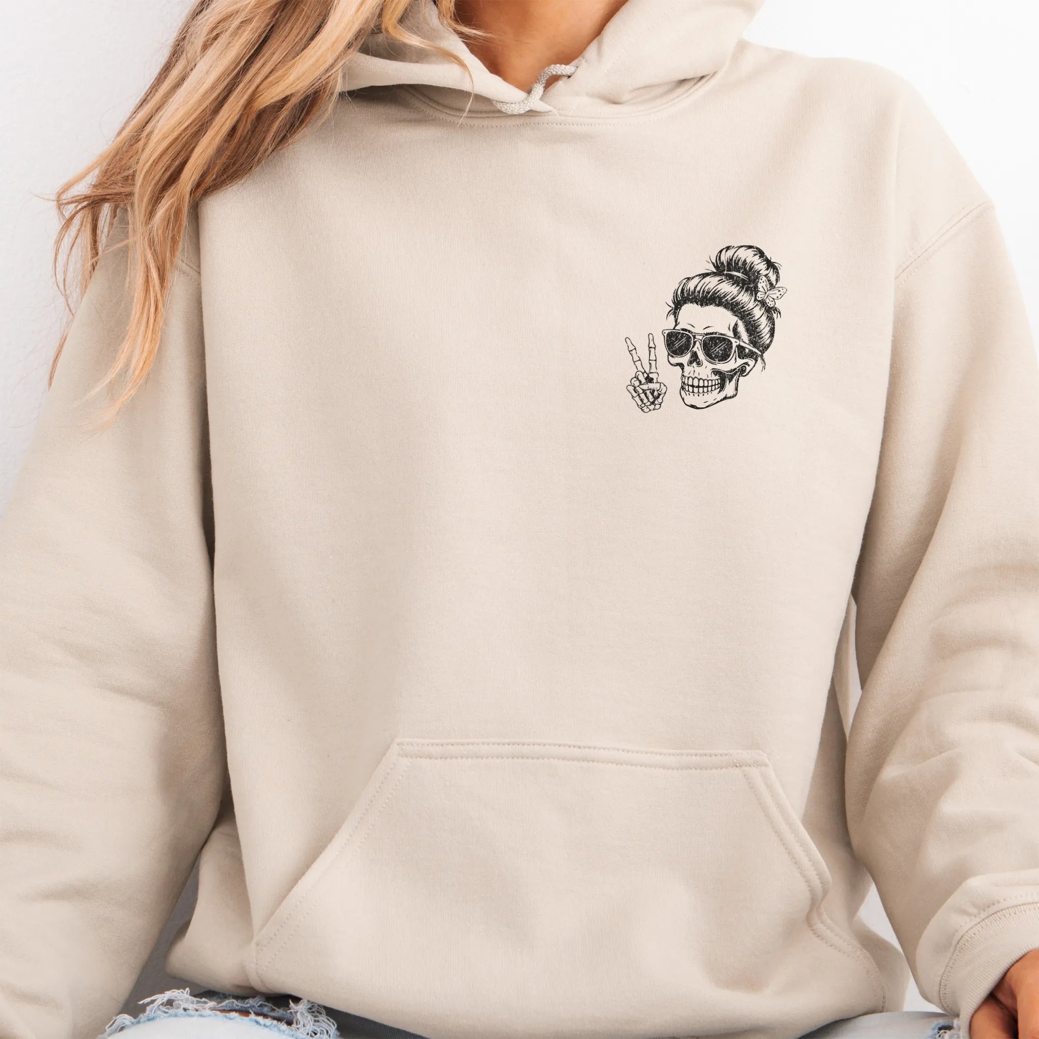 Sand Oakley June Hoodie front view small left chest skull with messy bun peace sign minimalist mark kangaroo pocket drawstrings visible distressed print
