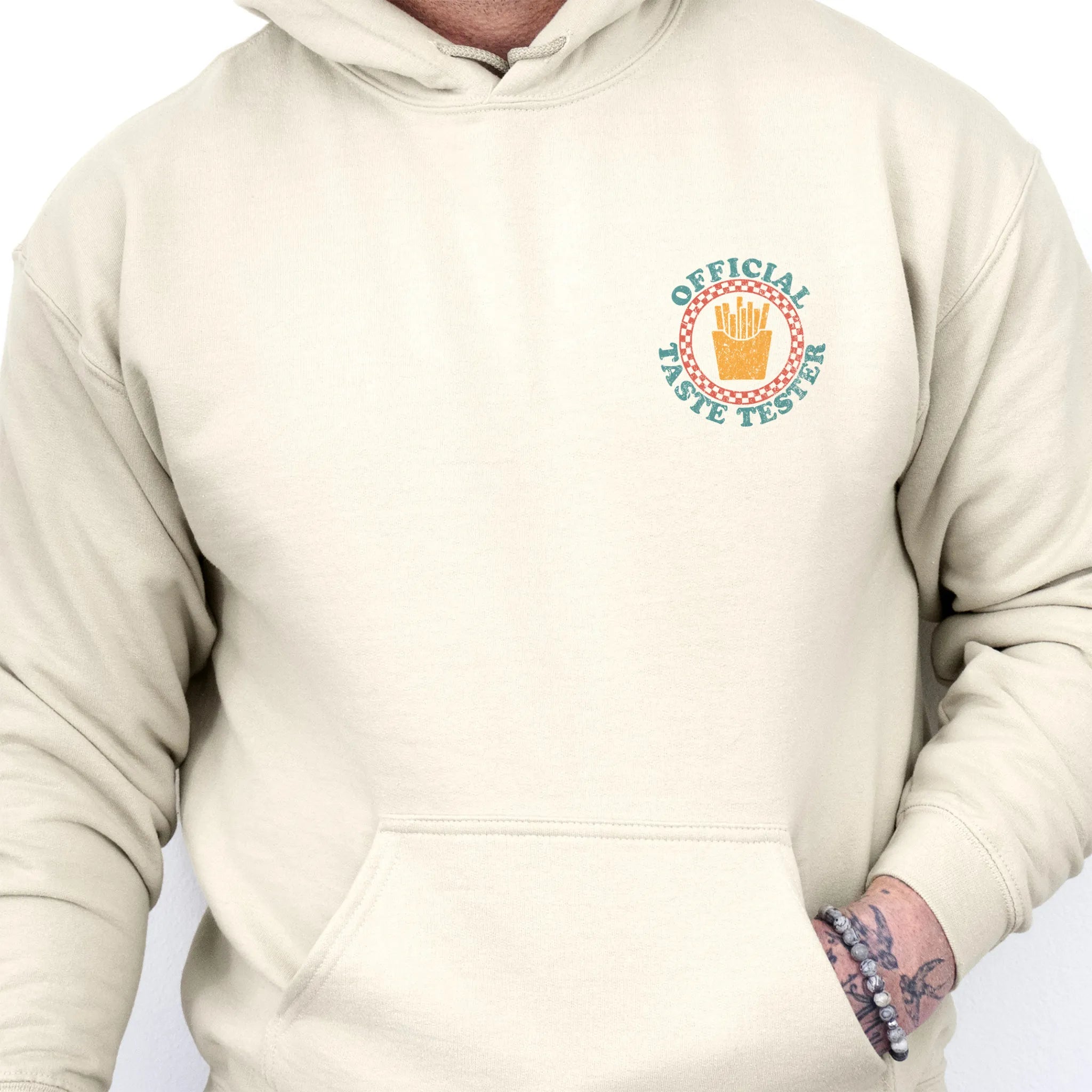 Sand Oakley June Hoodie front view Dad Tax Official Taste Tester left chest badge retro circle fries emblem kangaroo pocket drawstrings visible