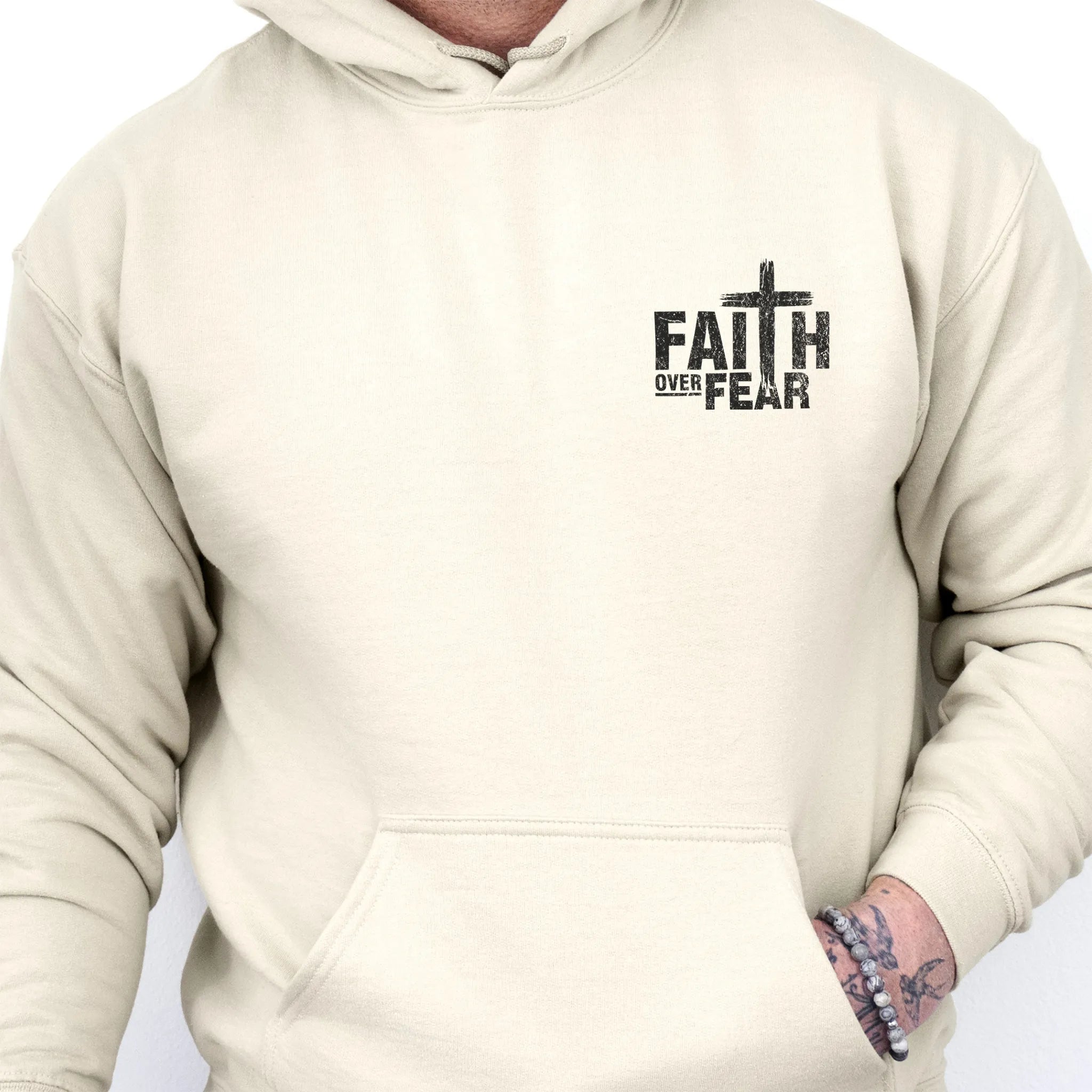 Sand Oakley June hoodie, mens fit, left chest badge reads Faith Over Fear with cross, kangaroo pocket, studio front view