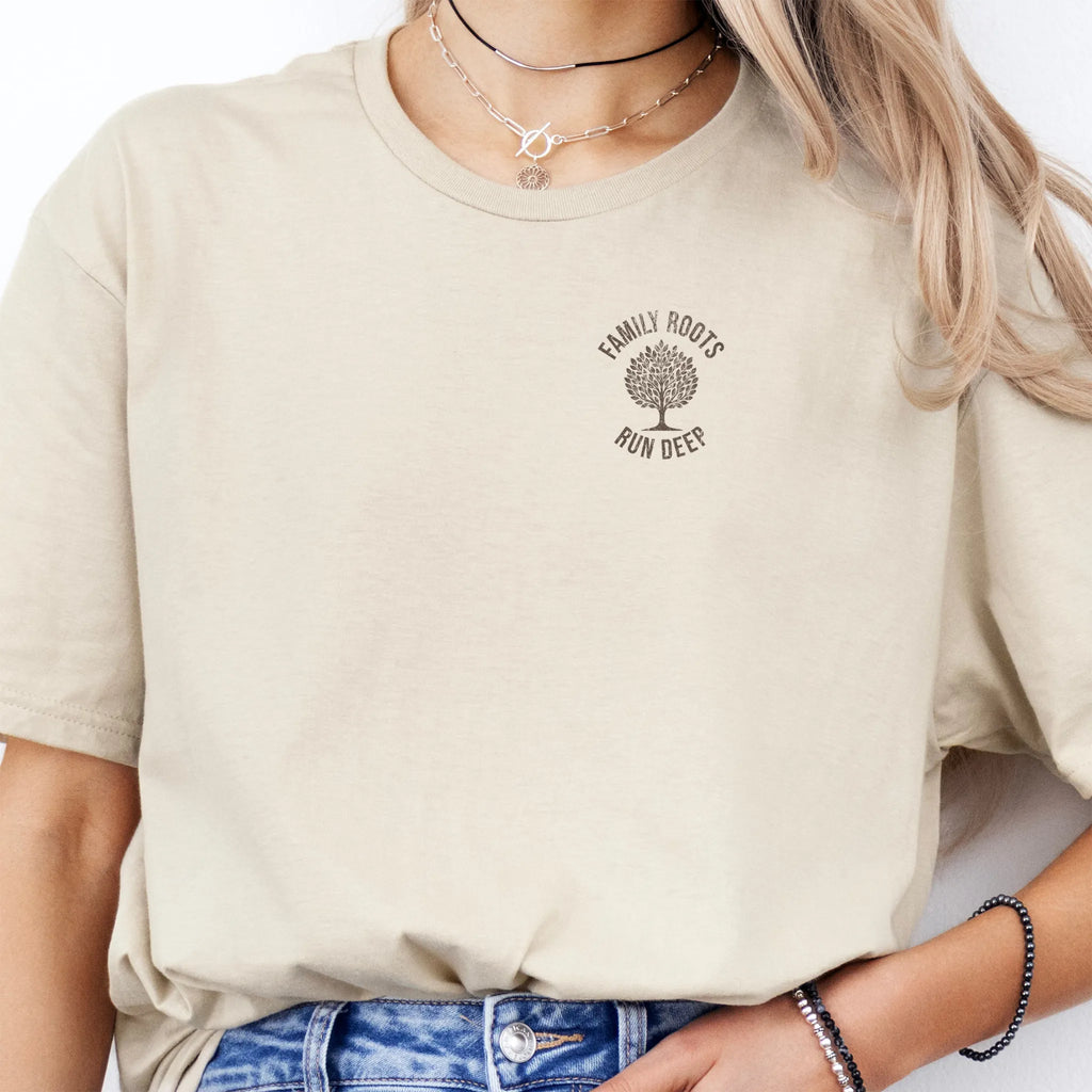 Sand Oakley June T-Shirt – left chest tree badge with text Family Roots Run Deep, soft unisex tee