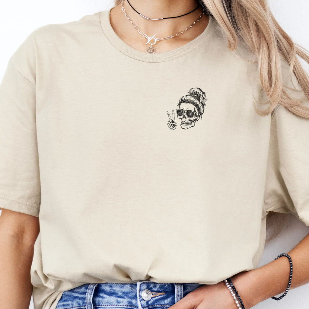 Sand Oakley June T Shirt front view small left chest skull with messy bun sunglasses peace sign minimalist mark distressed print