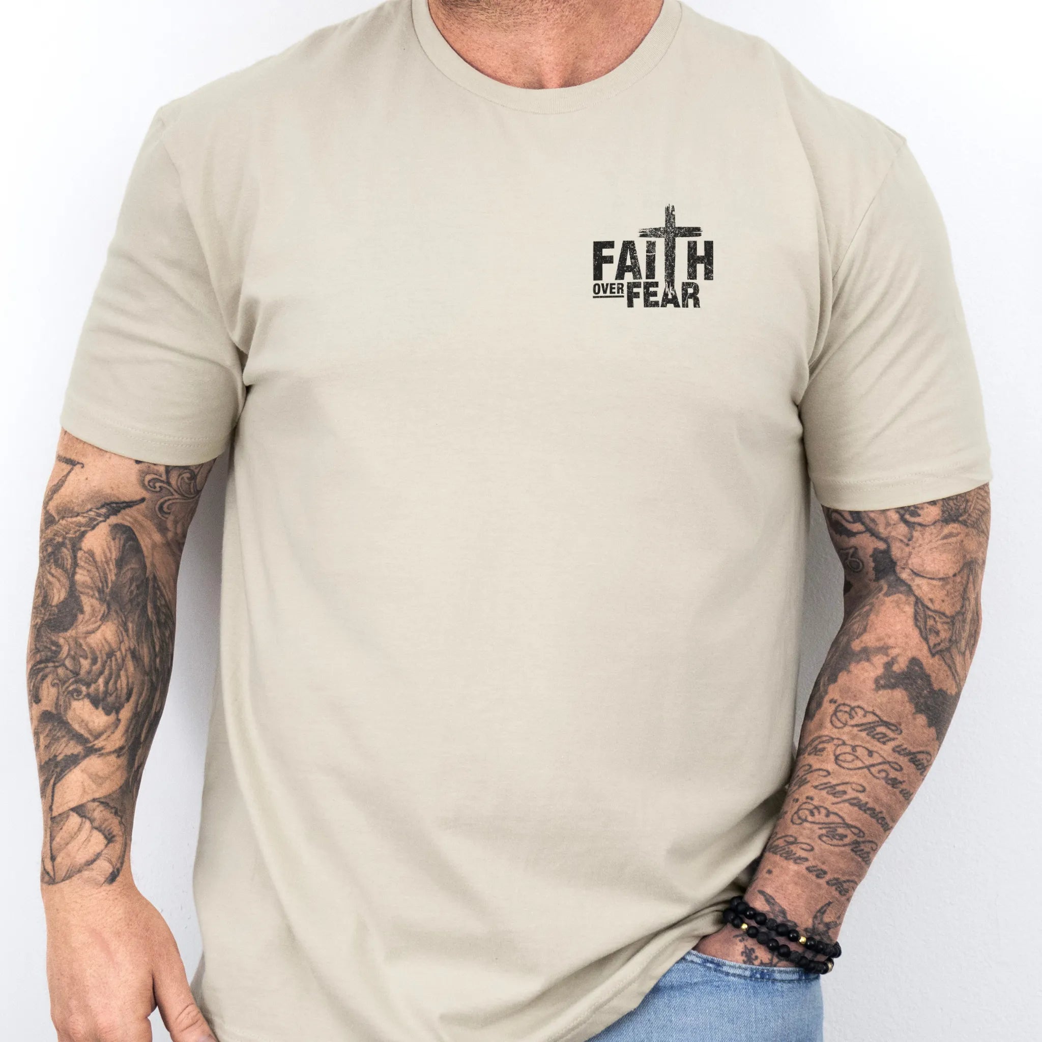 Sand Oakley June t shirt, mens fit, left chest badge reads Faith Over Fear with cross, studio front view